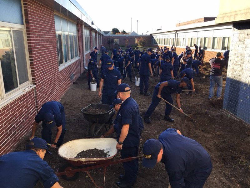 Recruits from Coast Guard Training Center (TRACEN) Cape May helped clear vegetation and debris from a courtyard Oct. 21 at Lower Cape May Regional High School.