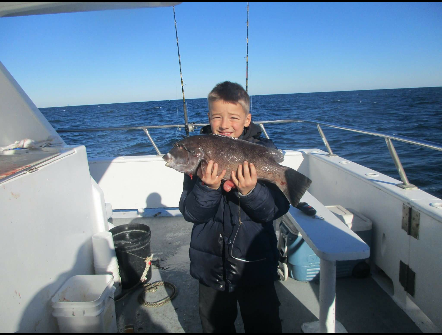 A happy young angler with his tog. 