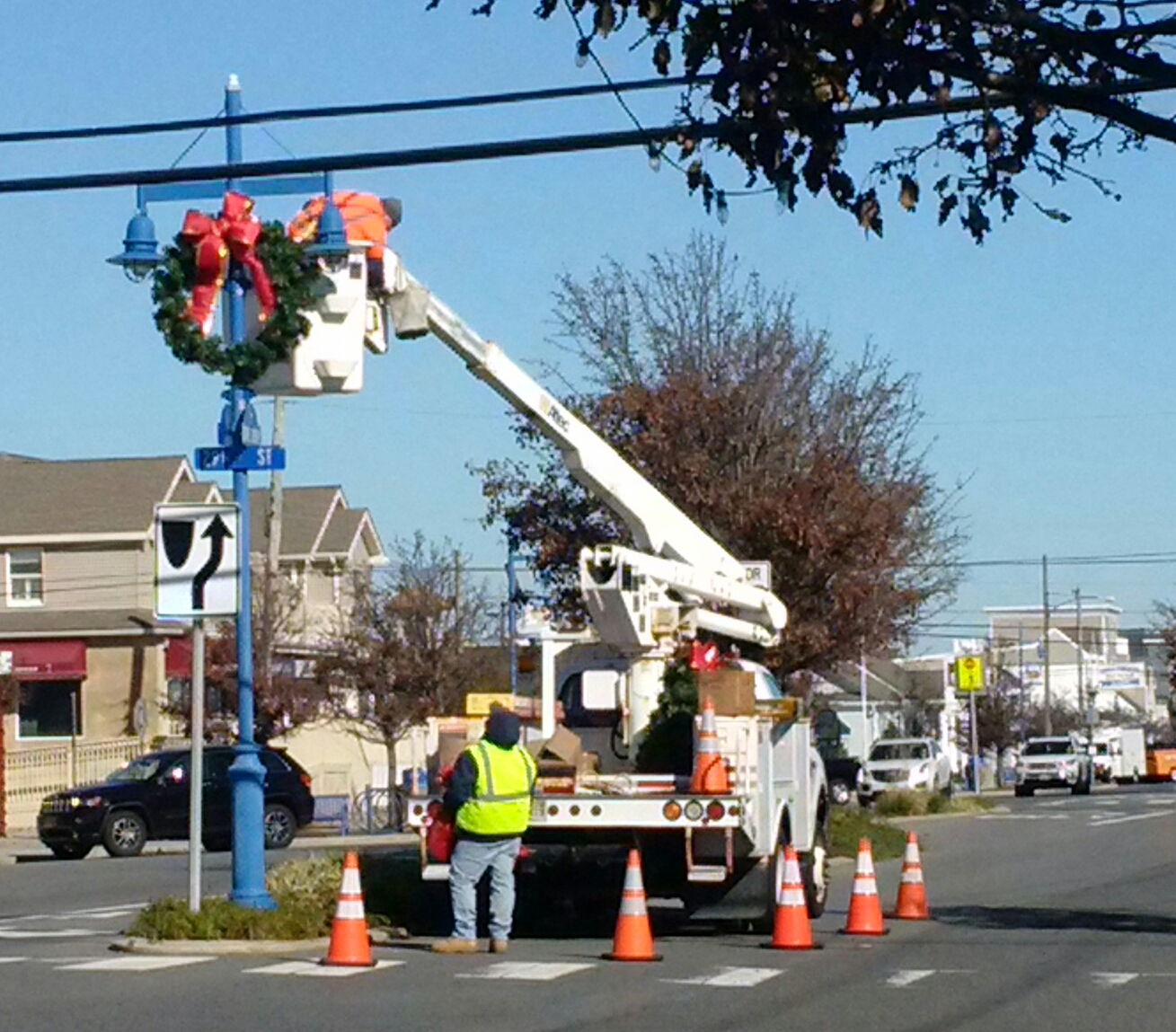 Avalon Department of Public Works employees put up wreaths and other Christmas decorations in the business district.