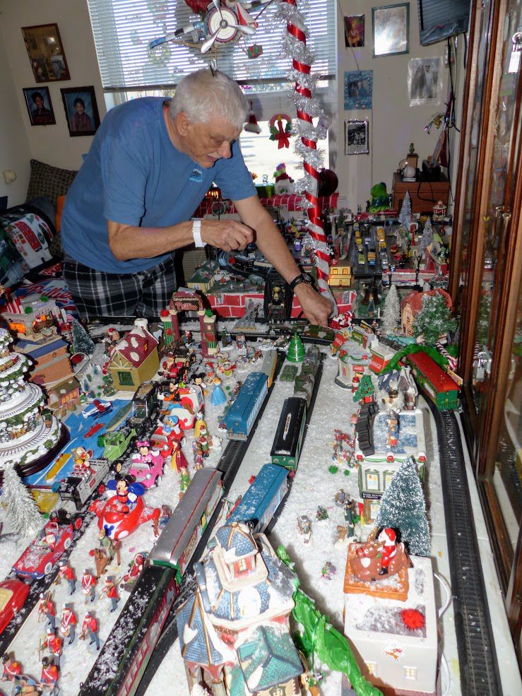 Frank Dachowski fixes his model train village set up especially for Christmas.