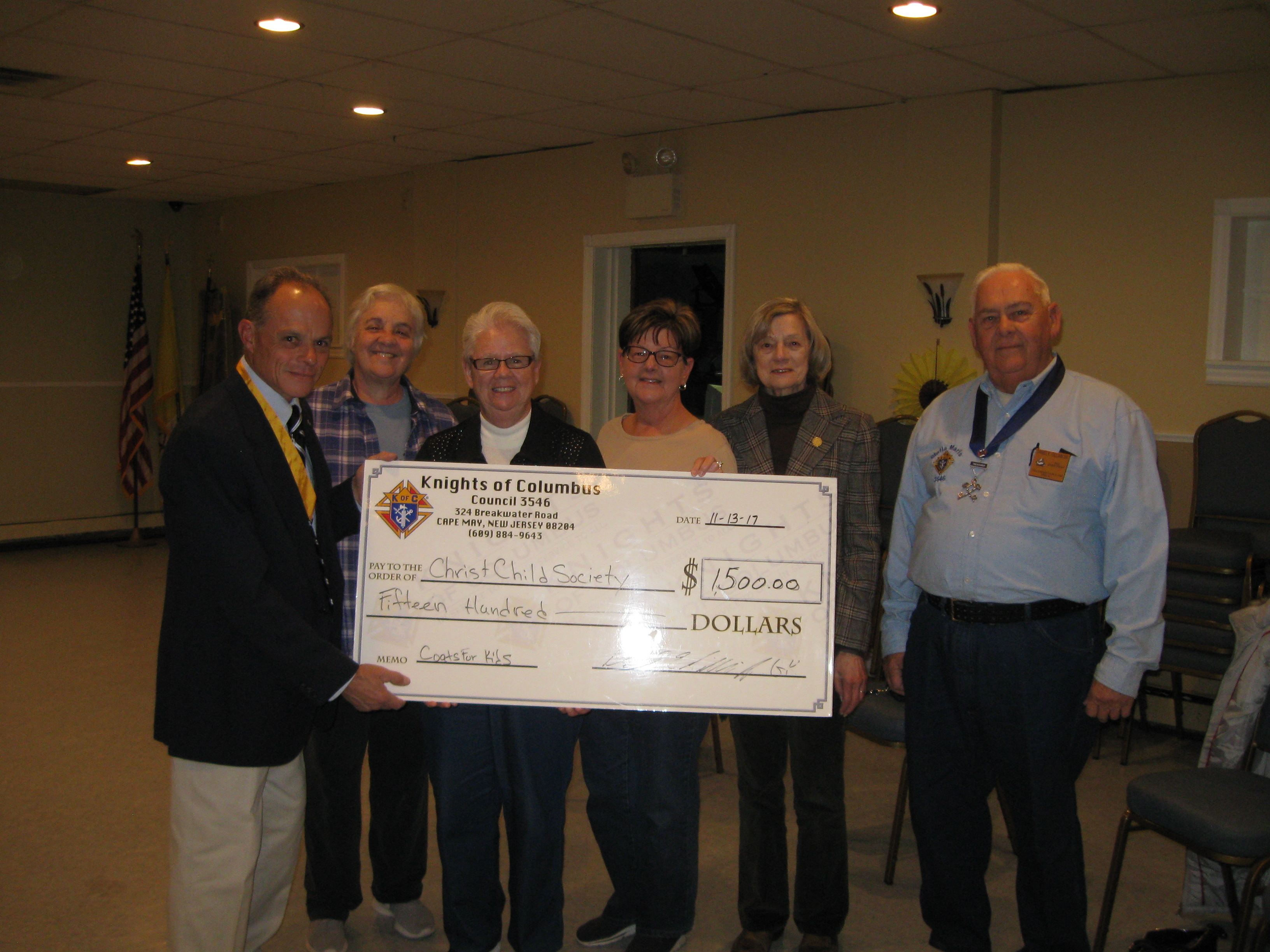 Stella Maris Knights of Columbus Presents Check to Christ Child Society of Star of the Sea Parish