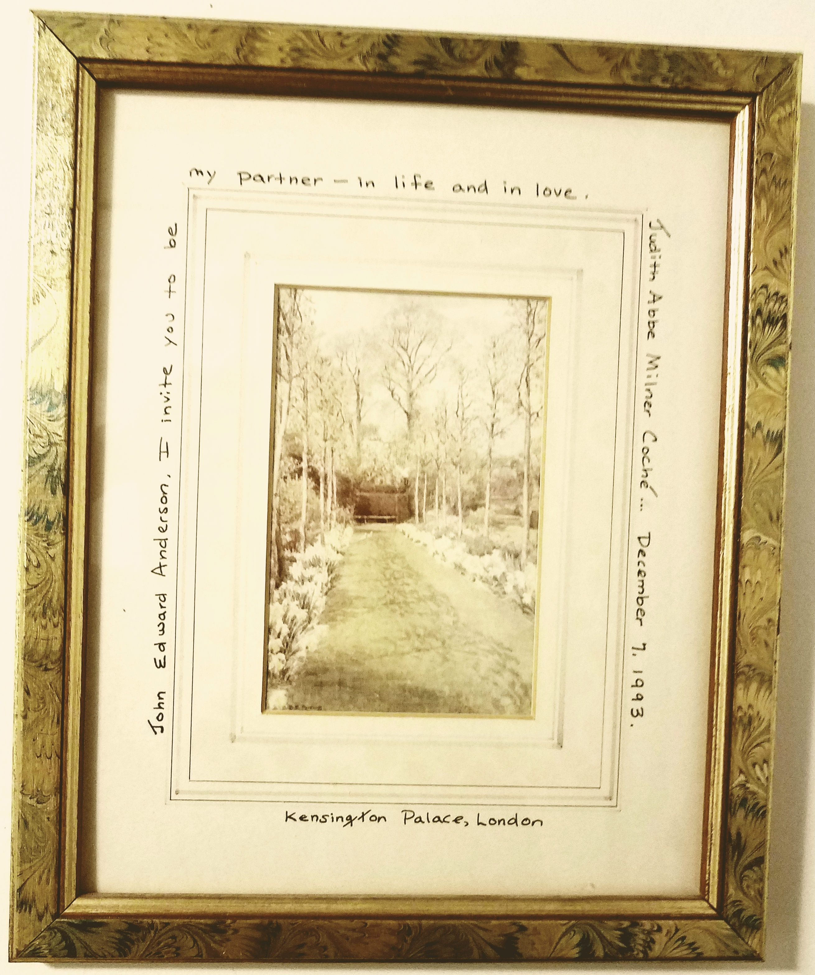 Dr. Judith Coche’s framed wedding pledge surrounds a drawing of a bench in Kensington gardens.