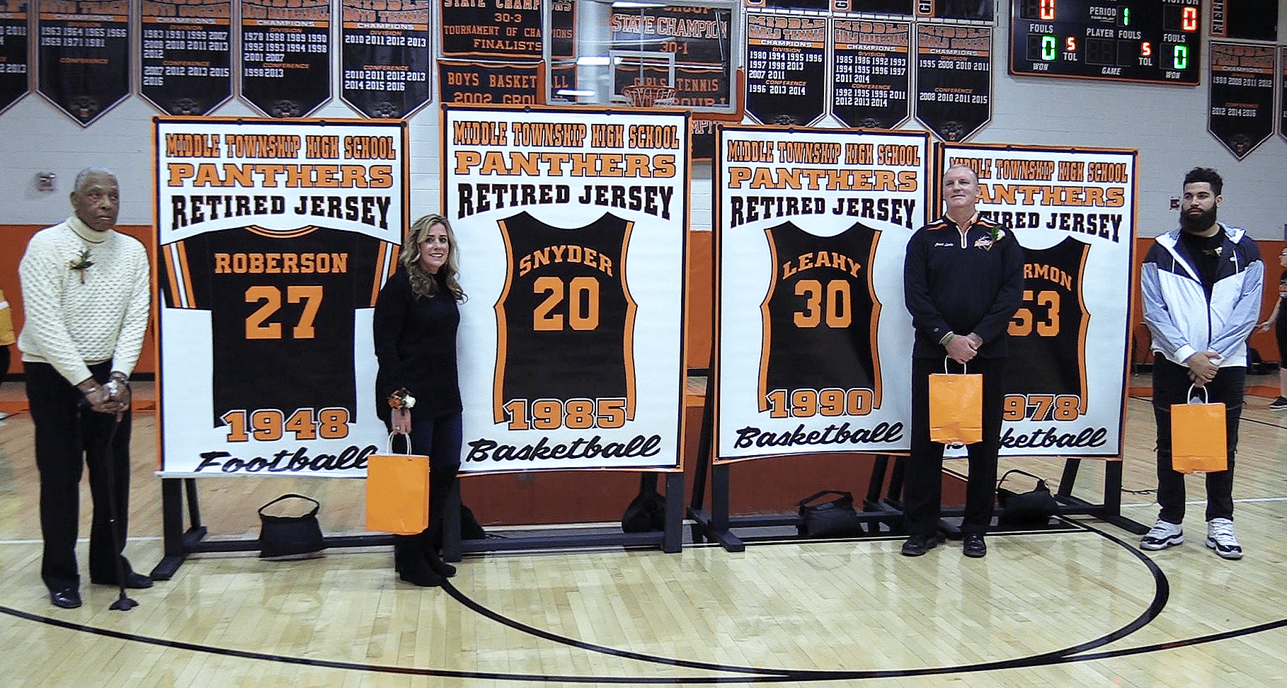 Middle Township High School Athletics honored four alumni athletes on Jan. 9 by unveiling new banners of their retired jerseys. Pictured from left to right