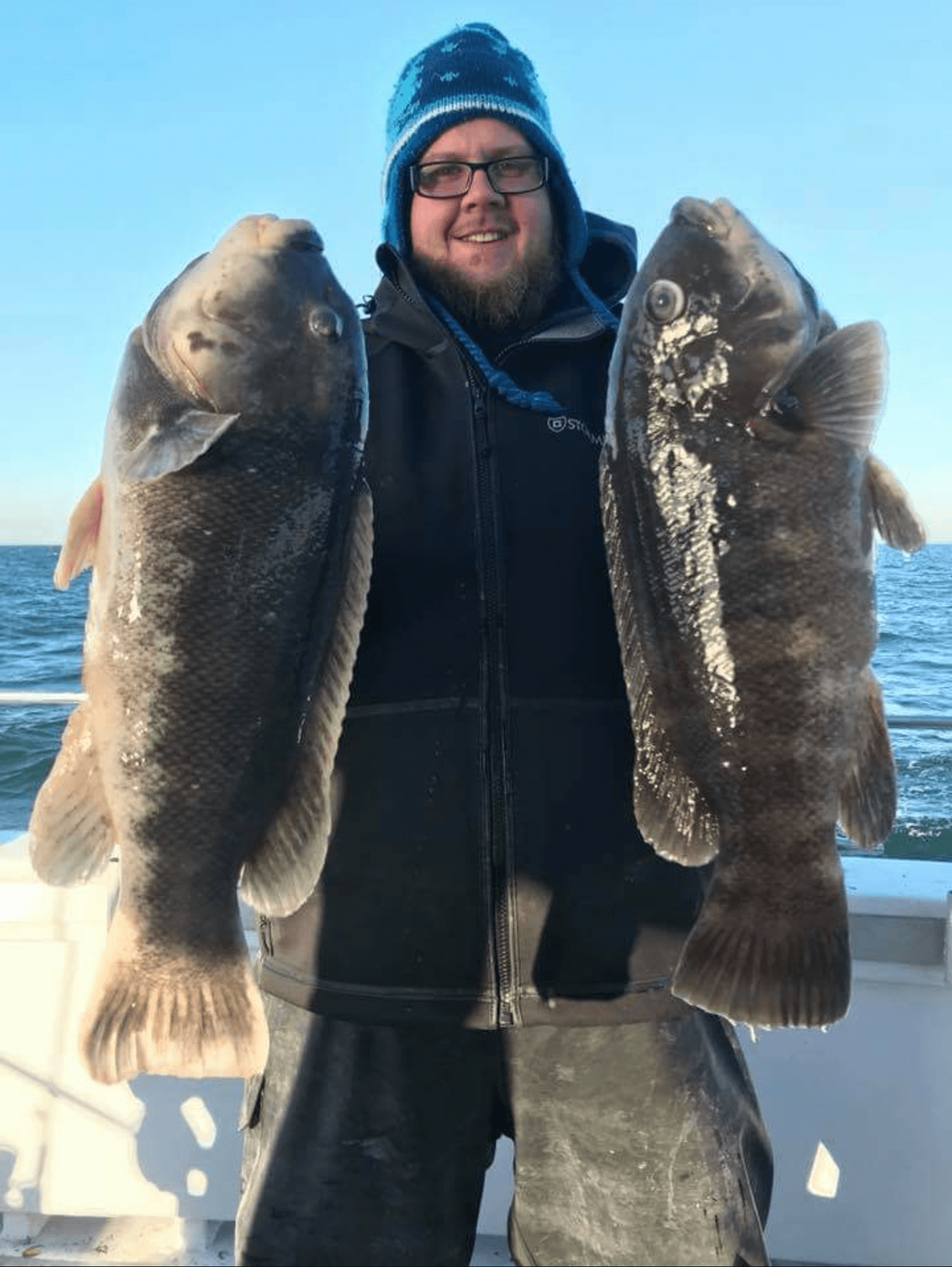 A happy angler with two nice tog. 