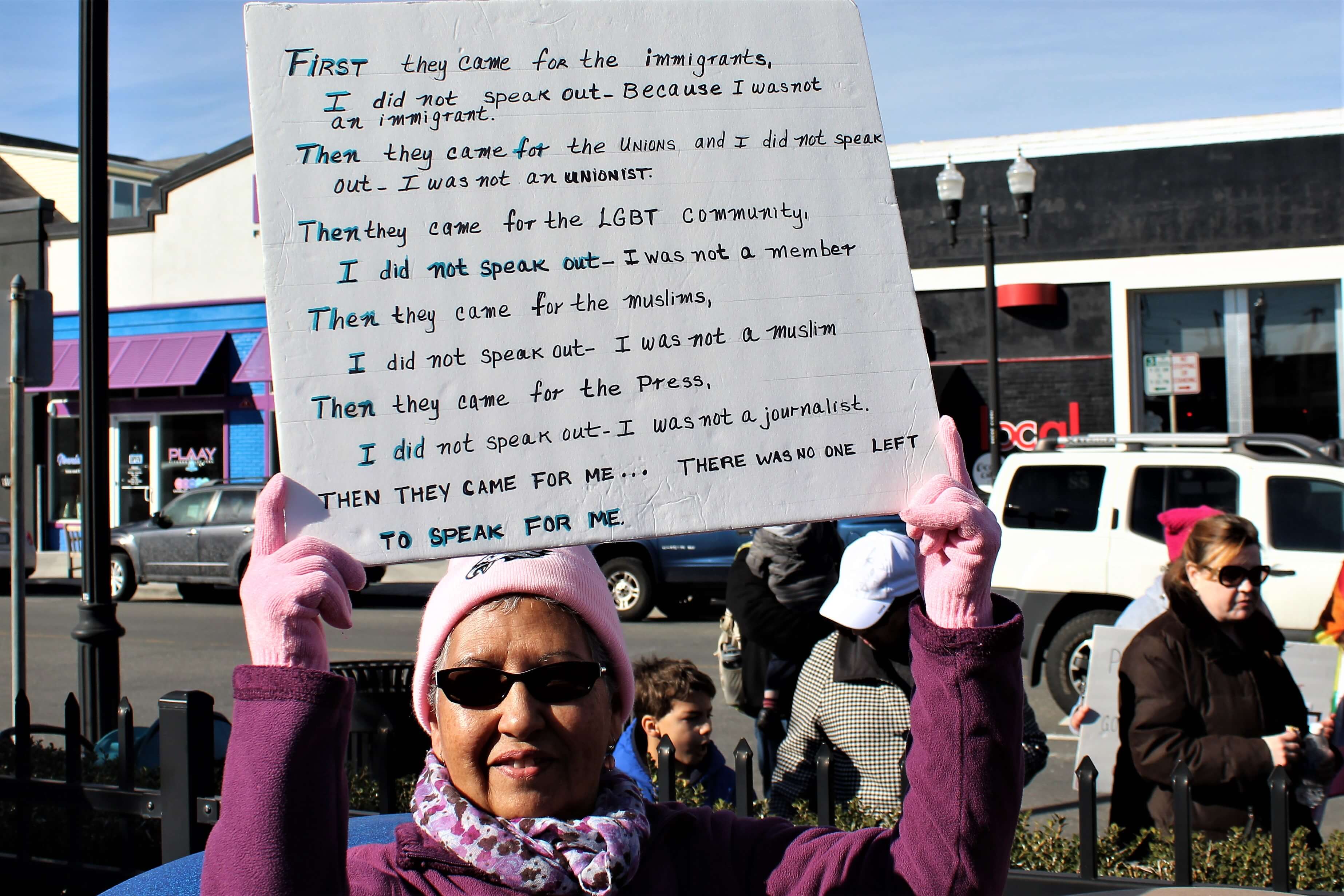 Luz Feliciano holds a sign that paraphrases Martin Niemoller’s famous poem about the rise of the Nazi regime in Germany. 