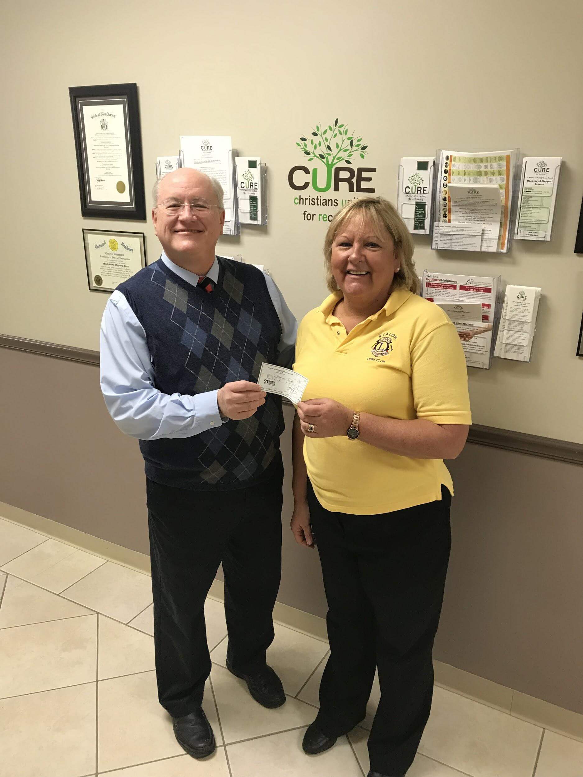 Avalon Lions Club Second Vice President Sue White presents a check to Lighthouse Church Pastor Charles Harrah.