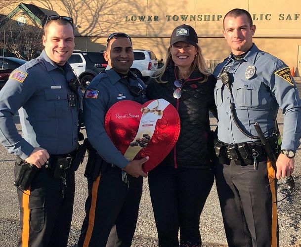 The dog's owner presents a gift to Patrolman Jordan Saini