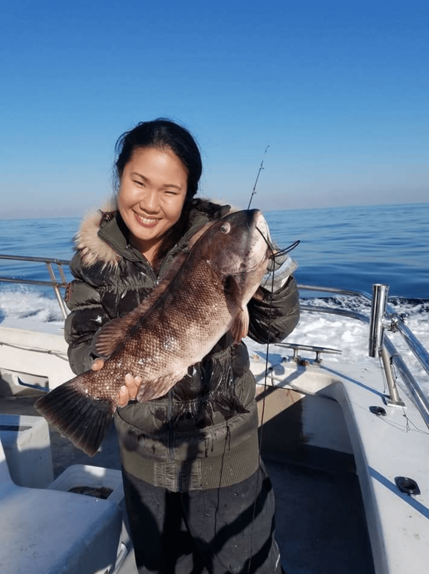 A happy angler with her tog. 