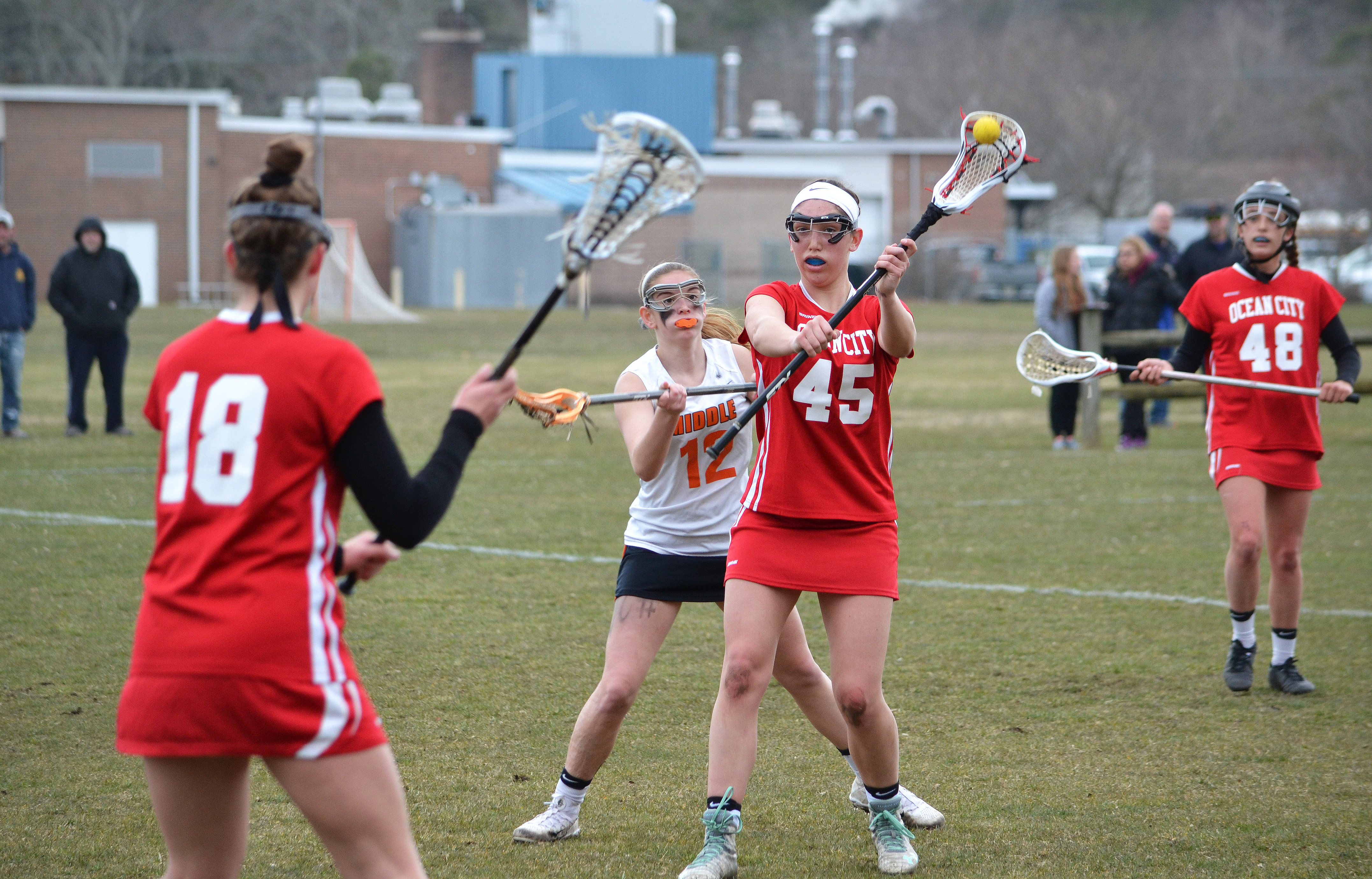 Ocean City's Danielle Donoghue (45) passes to Ashley Devlin in March 28's girls lacrosse game in Court House.