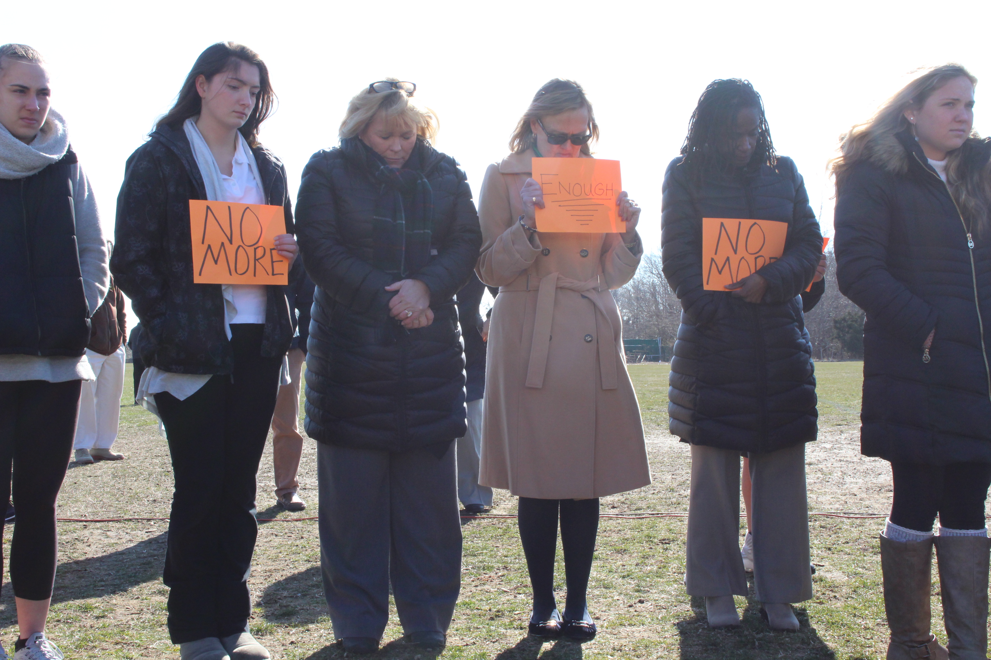 Faculty and students carry signs during a March 14 walkout at Middle Township High School protesting gun violence.