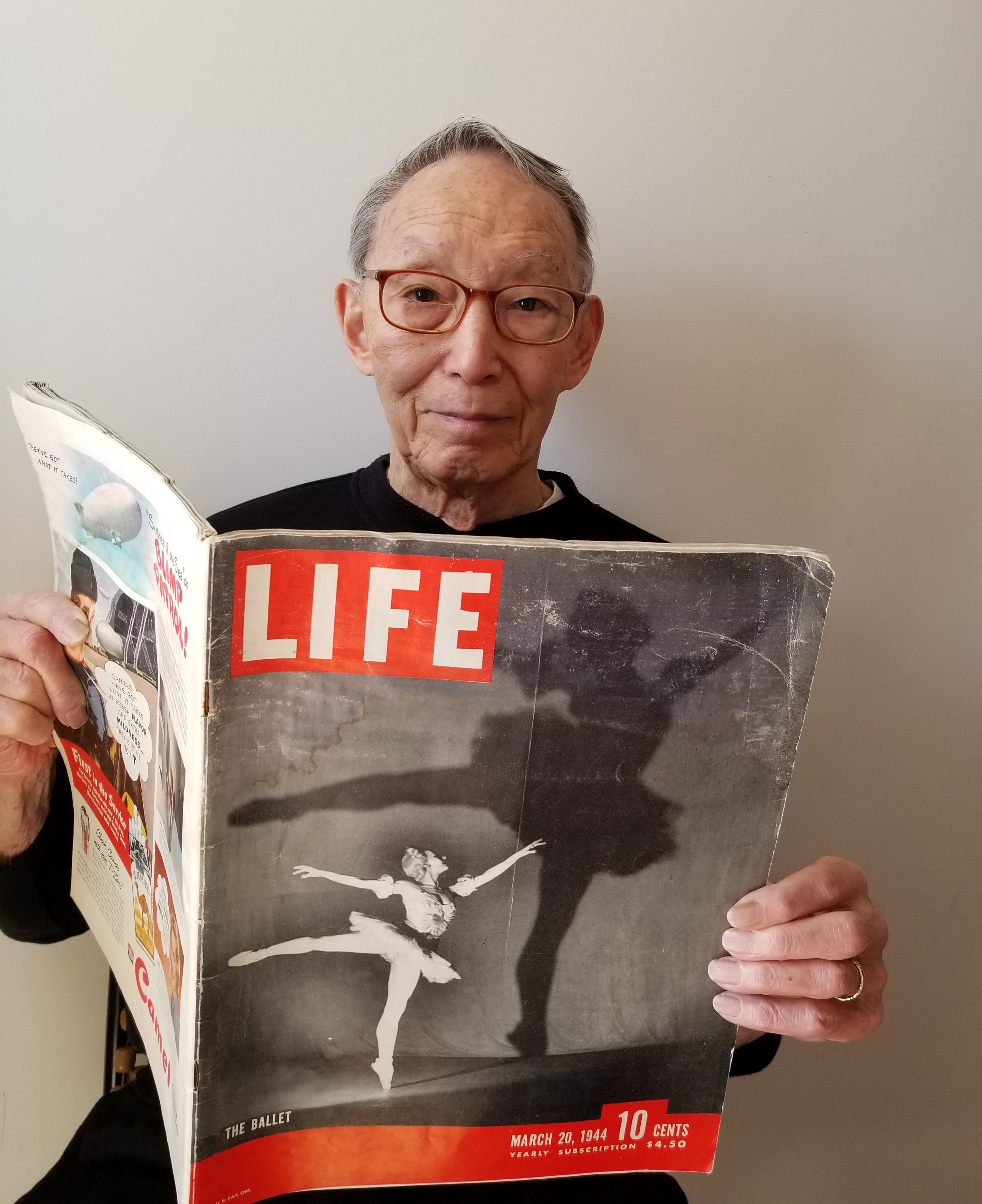 Ed Kobayashi holds a 1944 edition of "Life Magazine