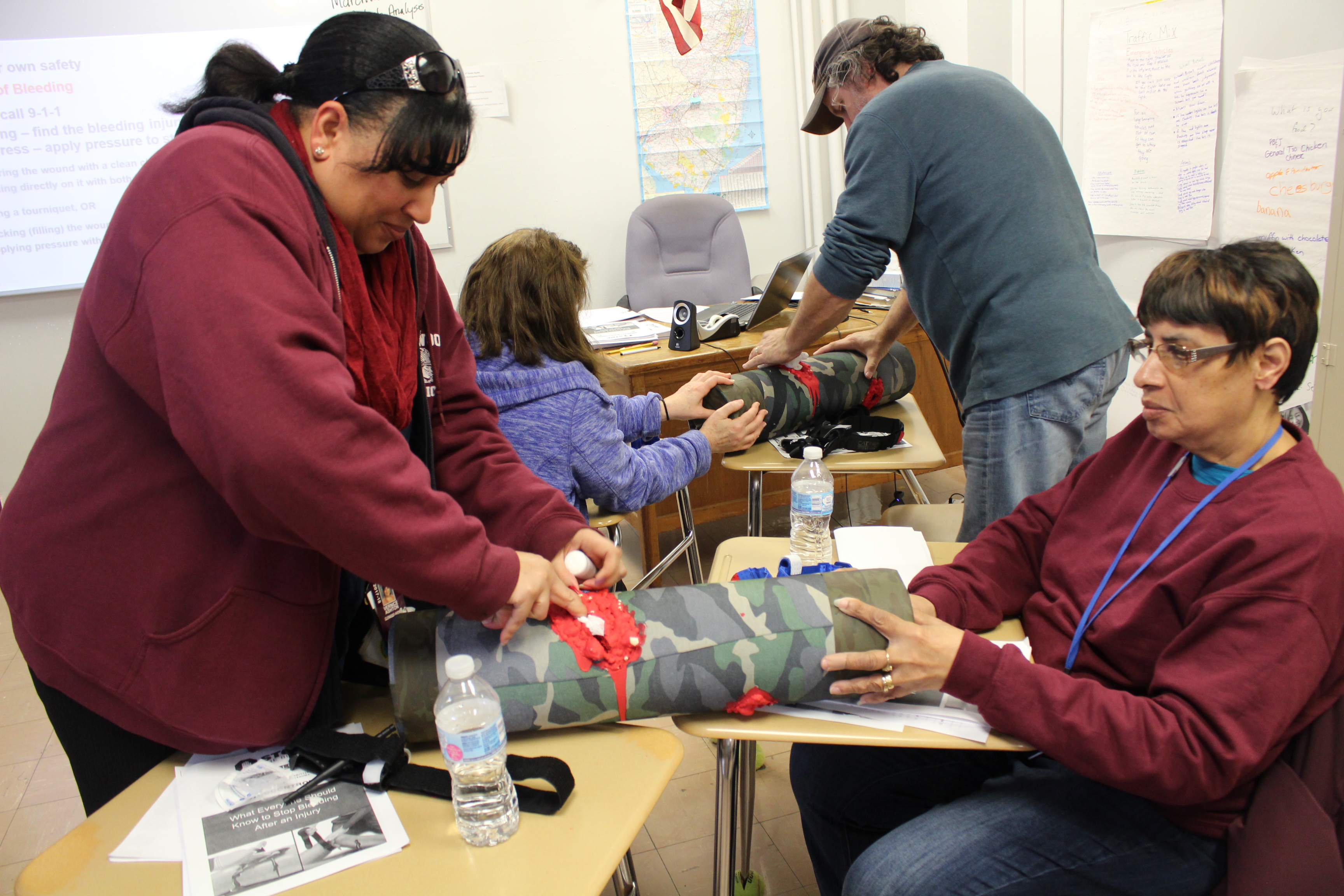 Wildwood School District faculty practice wound packing on a dummy leg.