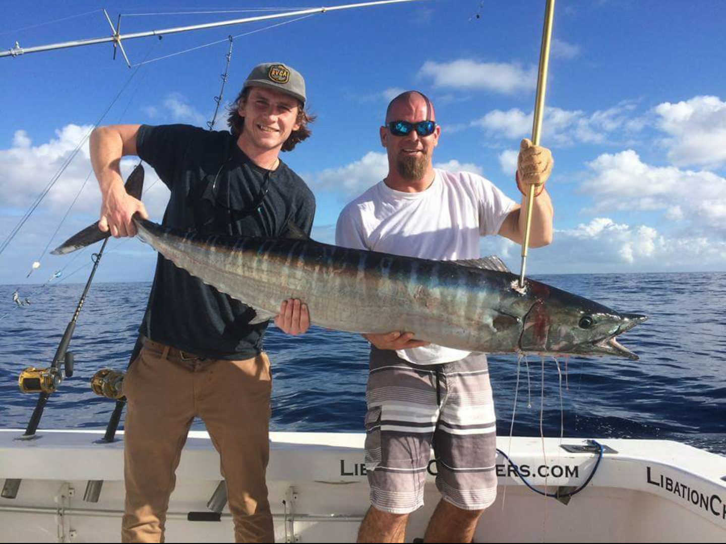 A couple of guys from Libation Charters and one of their six wahoo.