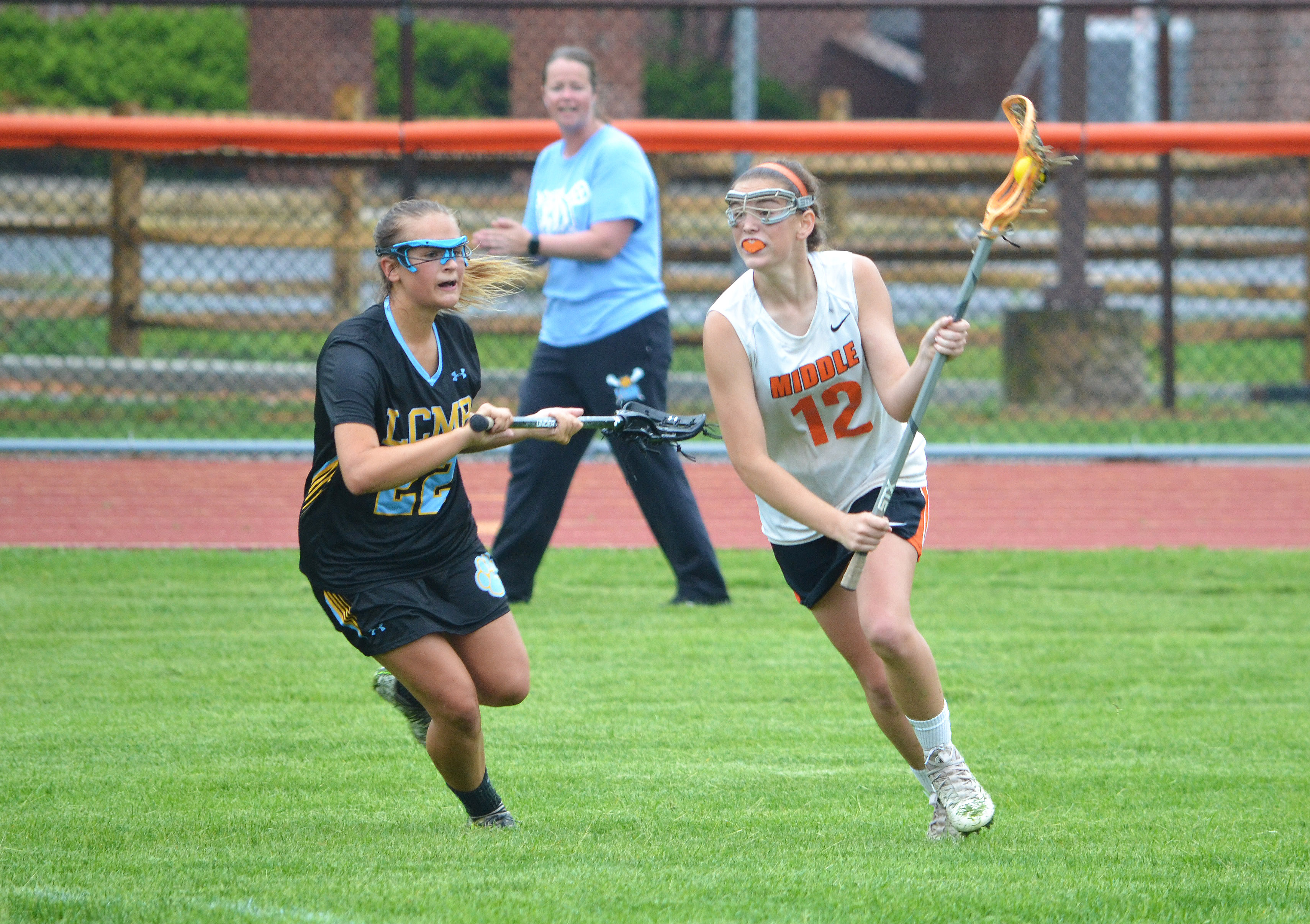 Middle Township's Maddie Barber (12) looks to move the ball past Lower Cape May's Jenna Durbin on May 17 at Memorial Field in Court House.