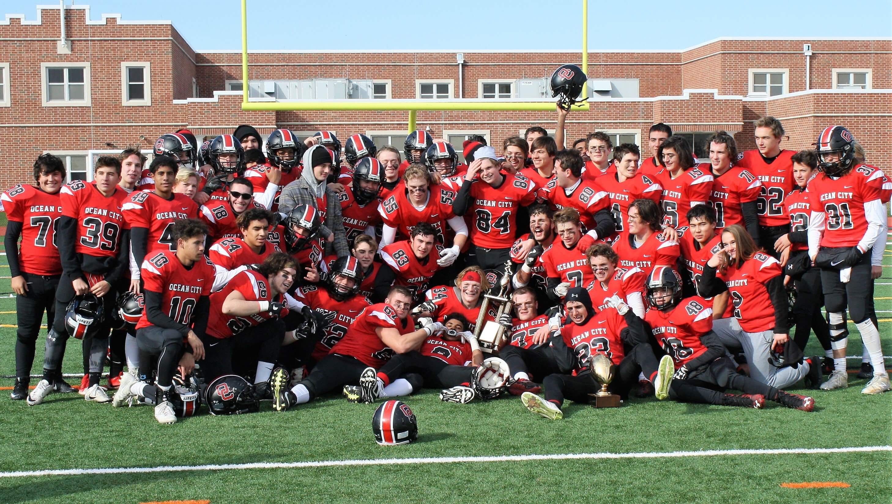 The Ocean City High School football team celebrates their 34-32 victory against Pleasantville on Nov. 23 at Carey Stadium.