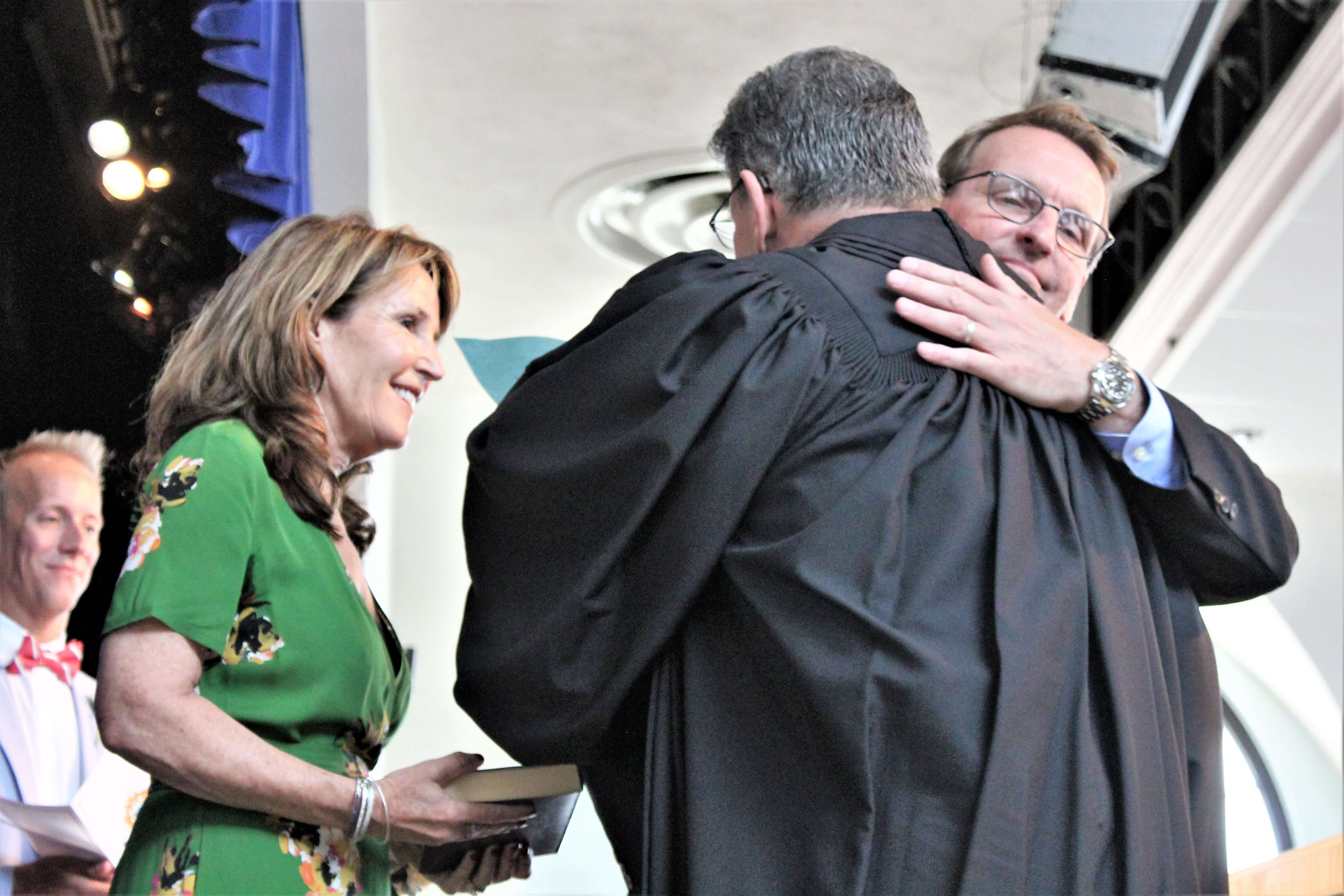 Jay Gillian embraces Judge Richard Russell after taking the oath of office for a third term as Ocean City’s mayor at the Ocean City Music Pier July 1. Michele Gillian