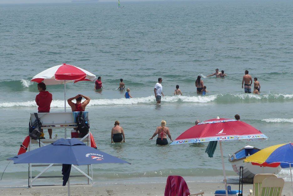 Swimmers wade into surf in Stone Harbor July 1.