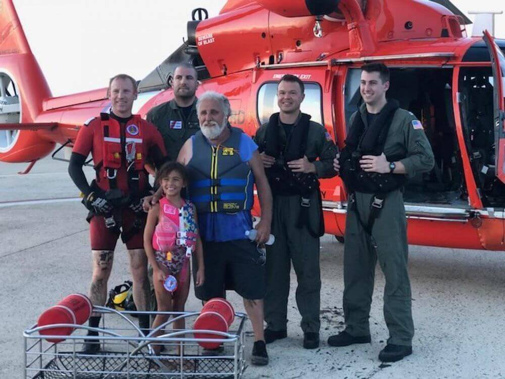 The grandfather and granddaughter rescued from Grassy Sound Aug. 30 and the Coast Guard helicopter crew that assisted them.