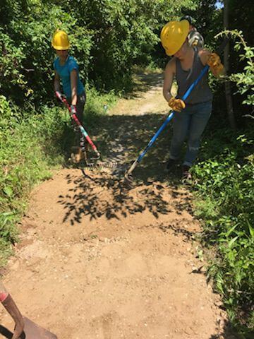 Two volunteers from the Student Conservation Association (SCA) rake dirt on one of the three trails at Cape May Point State Park despite high temperatures and humidity. The teens spent three weeks doing conservation efforts at several New Jersey state parks as part of the SCA’s mission to build the next generation of conservation leaders. 