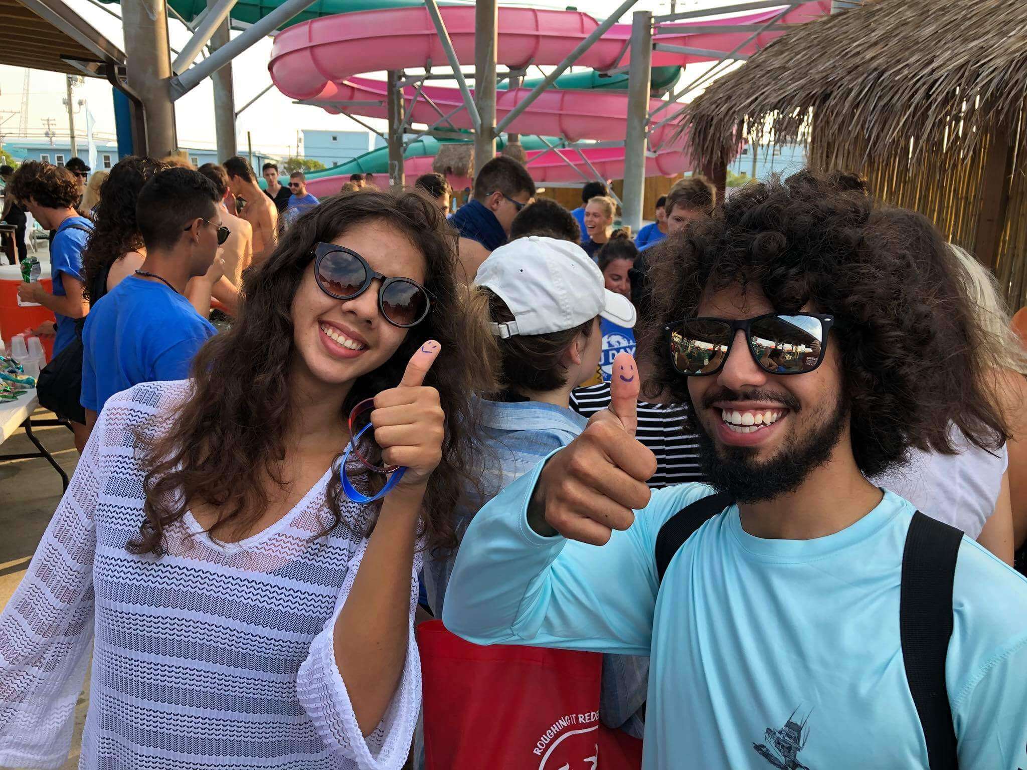 Two students attending a Wildwood community event give a "thumbs up" indicating they will "pay it forward with random acts of kindness to help change the world." The message is from the Lunch with Lynch Foundation