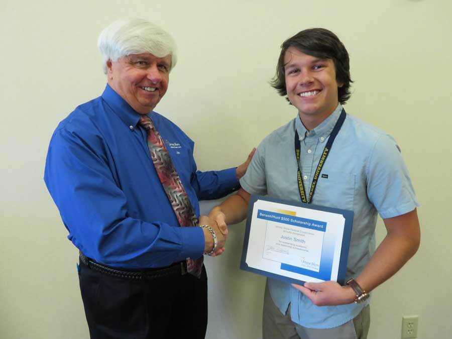 Credit Union President/CEO James Burns presents the $500 Benson/Hunt Scholarship to Justin Smith.