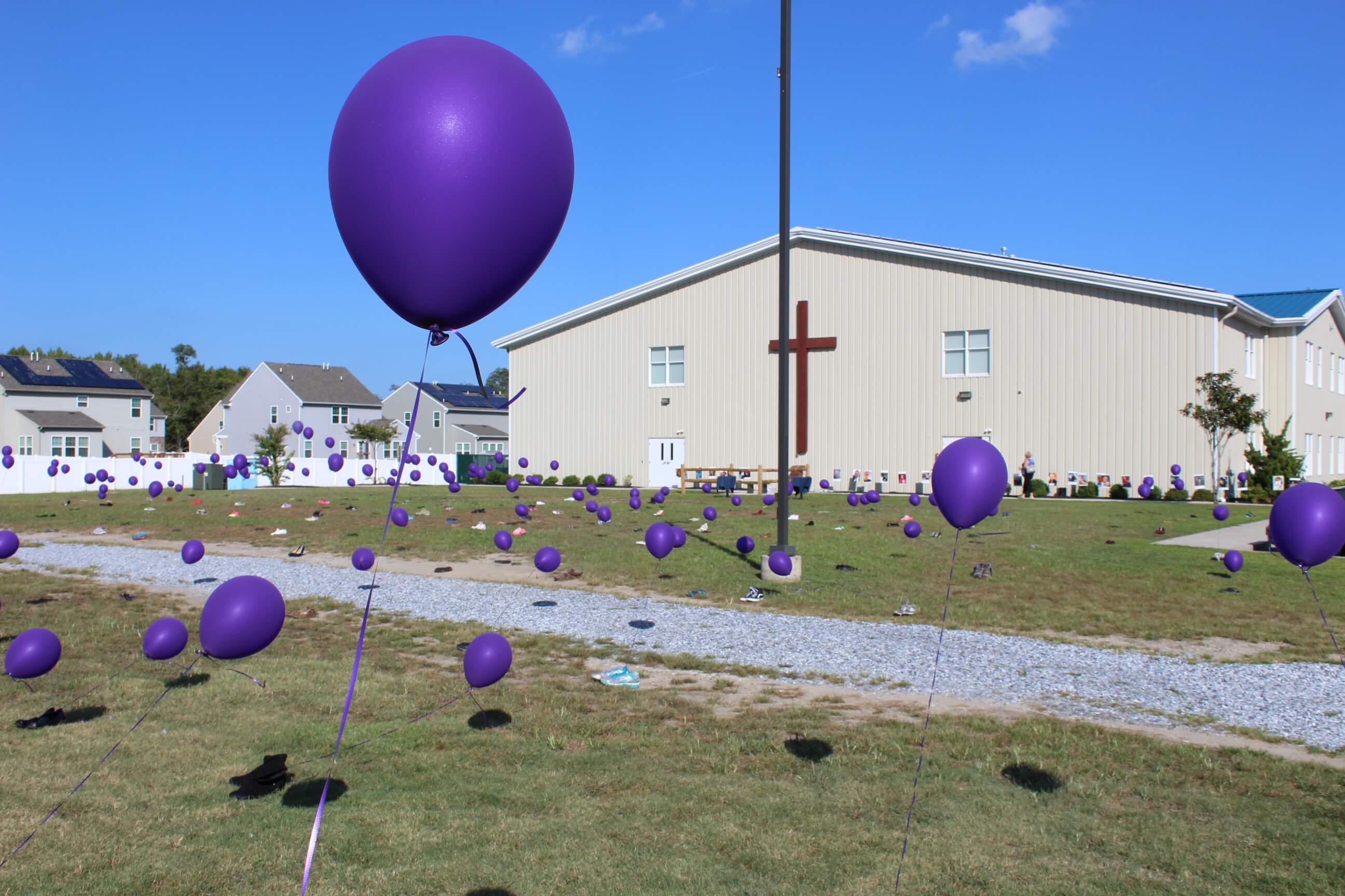 Balloons fly outside The Lighthouse Church in Burleigh Aug. 30 to commemorate persons lost to opioid addiction. The event celebrated the efforts of the church and its CURE (Christians United for Recovery)