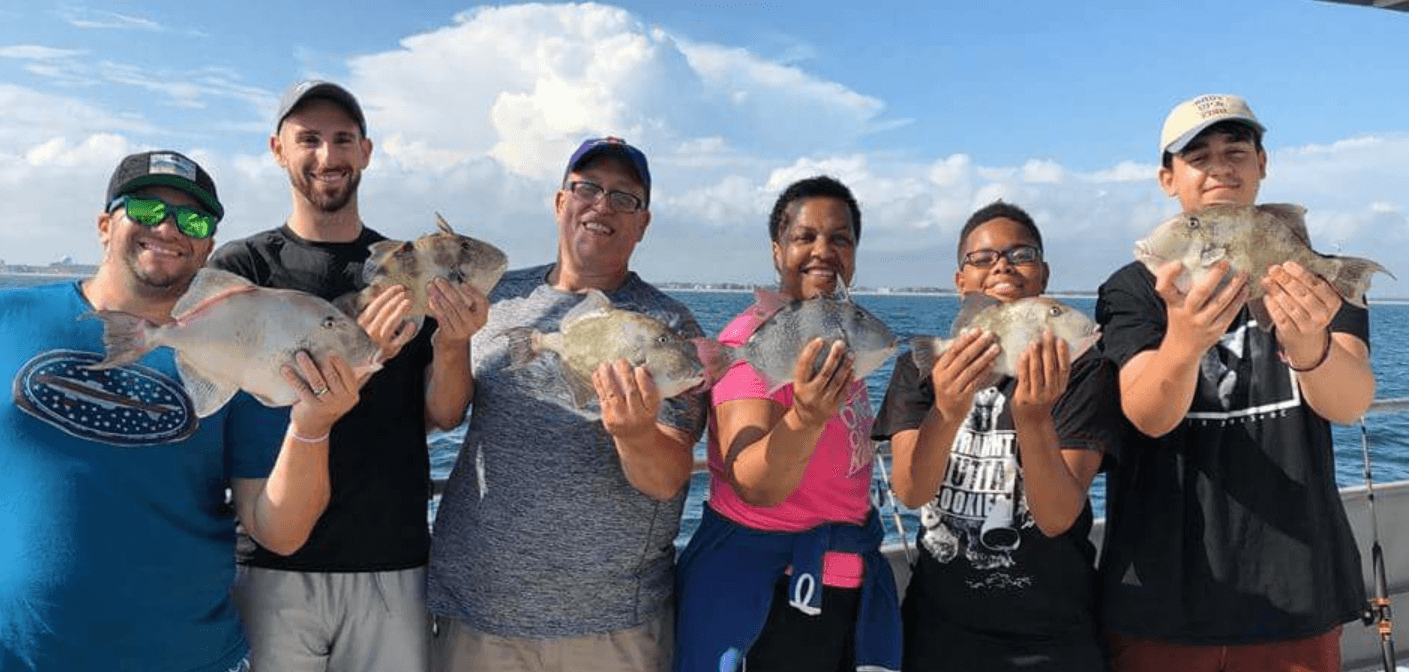 Happy anglers and their triggerfish.