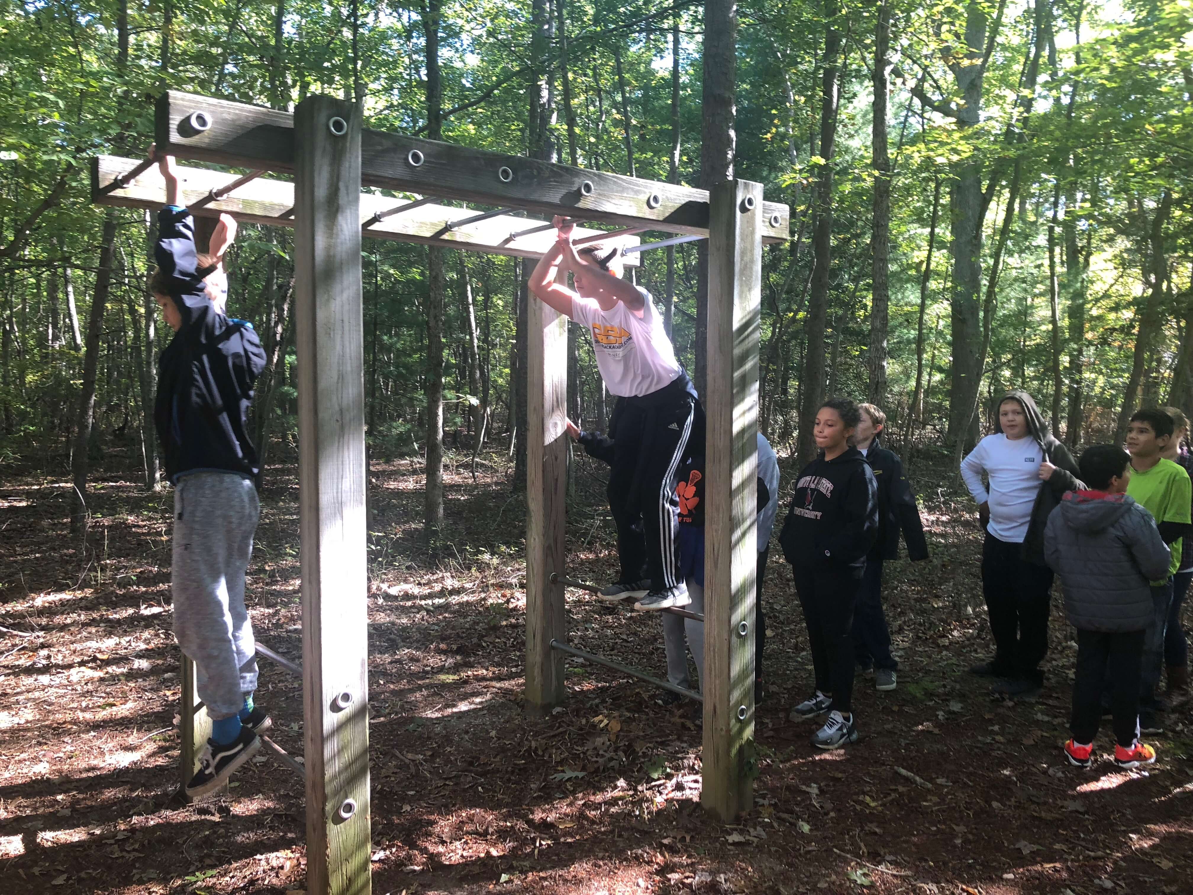 Middle Township Middle School students cheer each other on as they cross the monkey bars during the 19th Annual Sixth Grade Outdoor Experience.