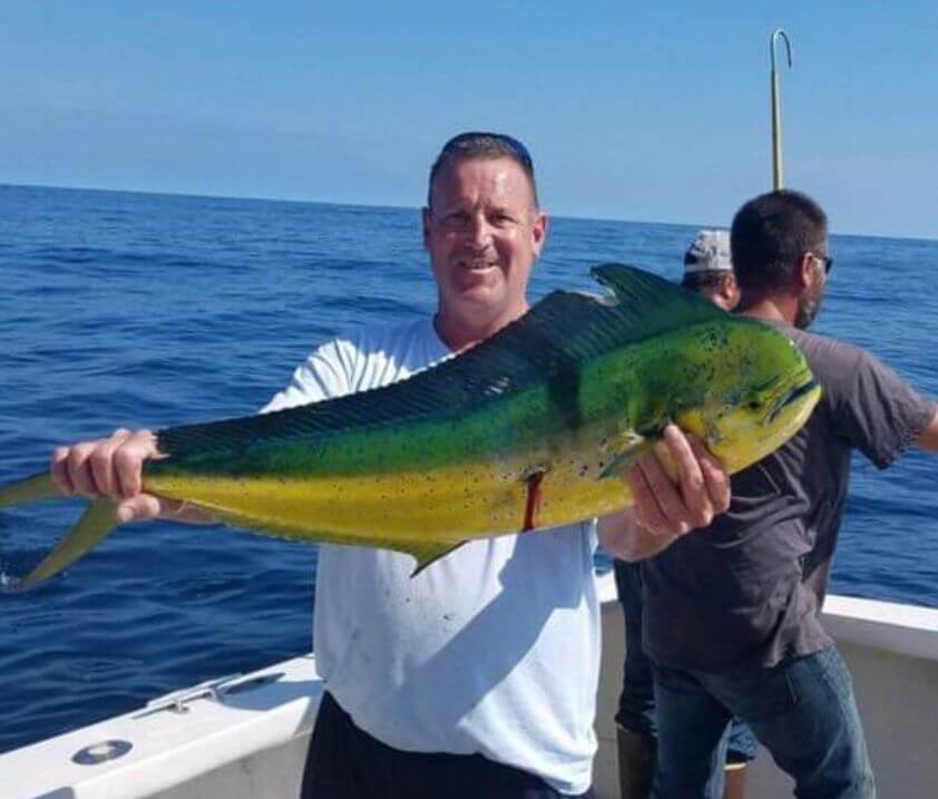 A happy angler with his mahi-mahi.