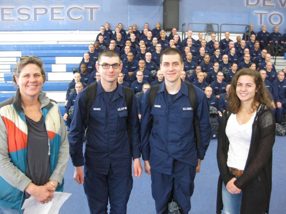 Lisa and Laura Shriver pose with seaman recruits for a photo during the annual Christmas Operation Fireside