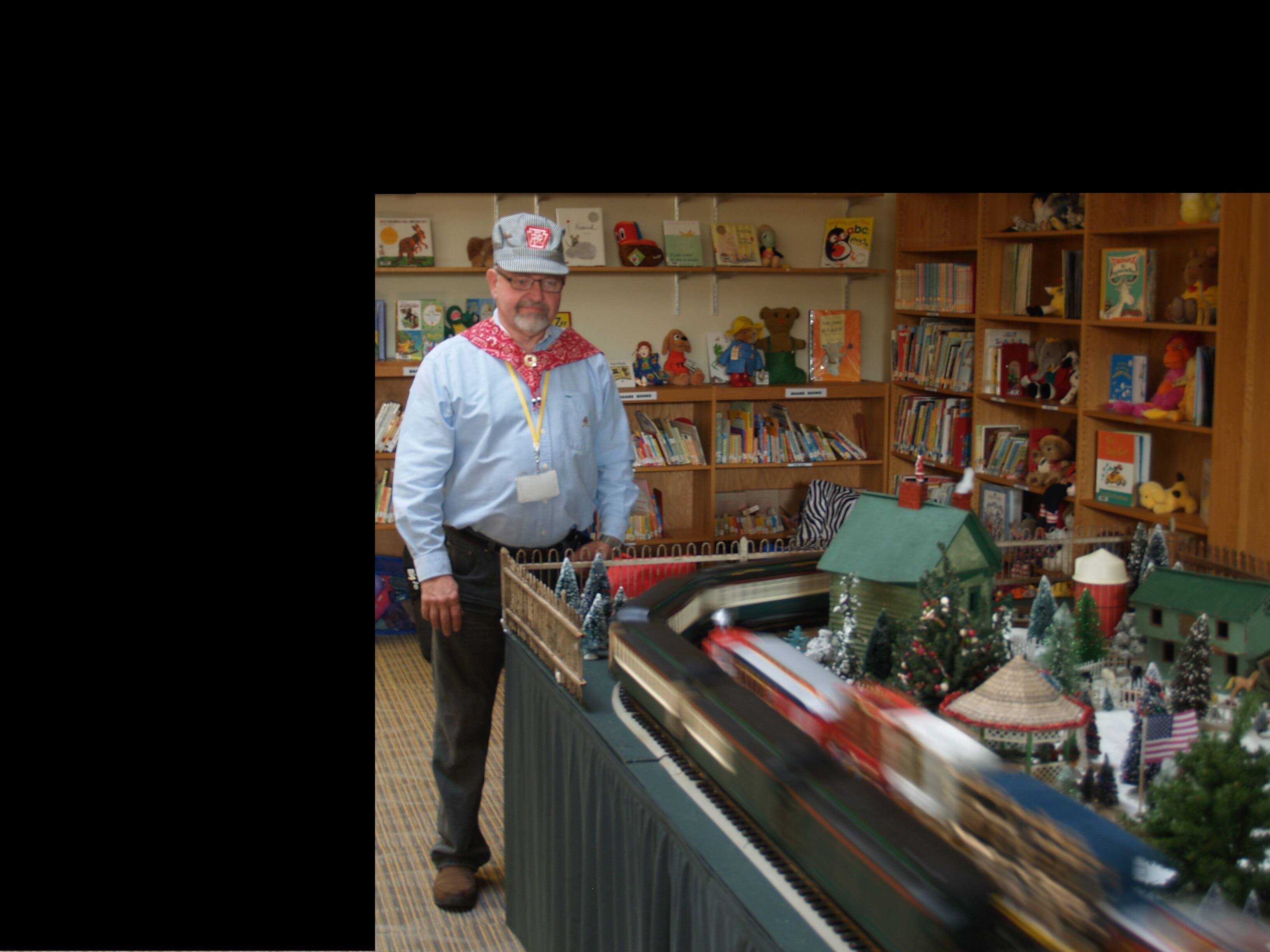 Dave Calvert operates model train display that students from Special Services School saw during their pre-holiday week.