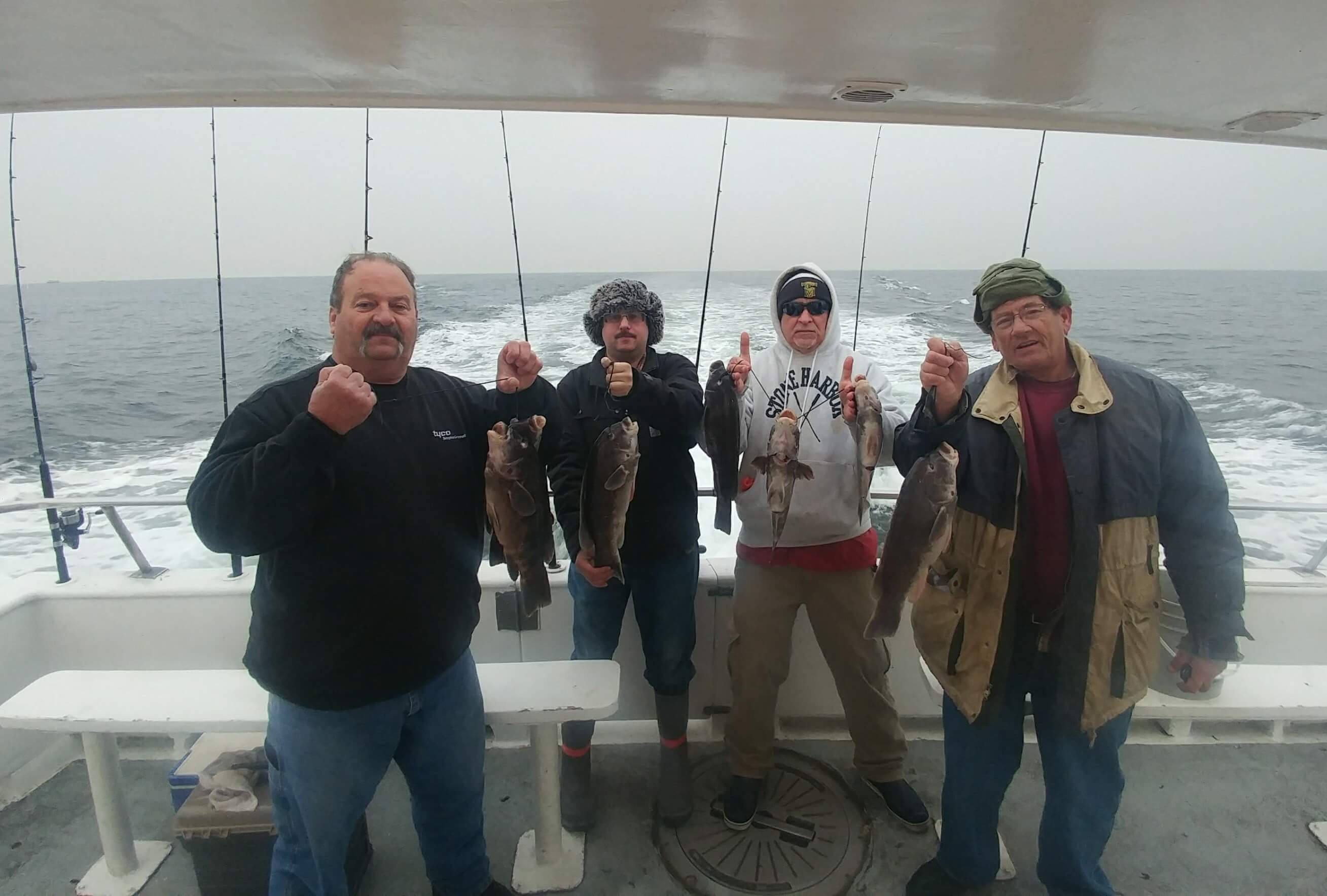 Four happy anglers with their tog.