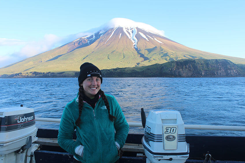 Bobbi Hornbeck during her fieldwork with Segula Volcano in the background