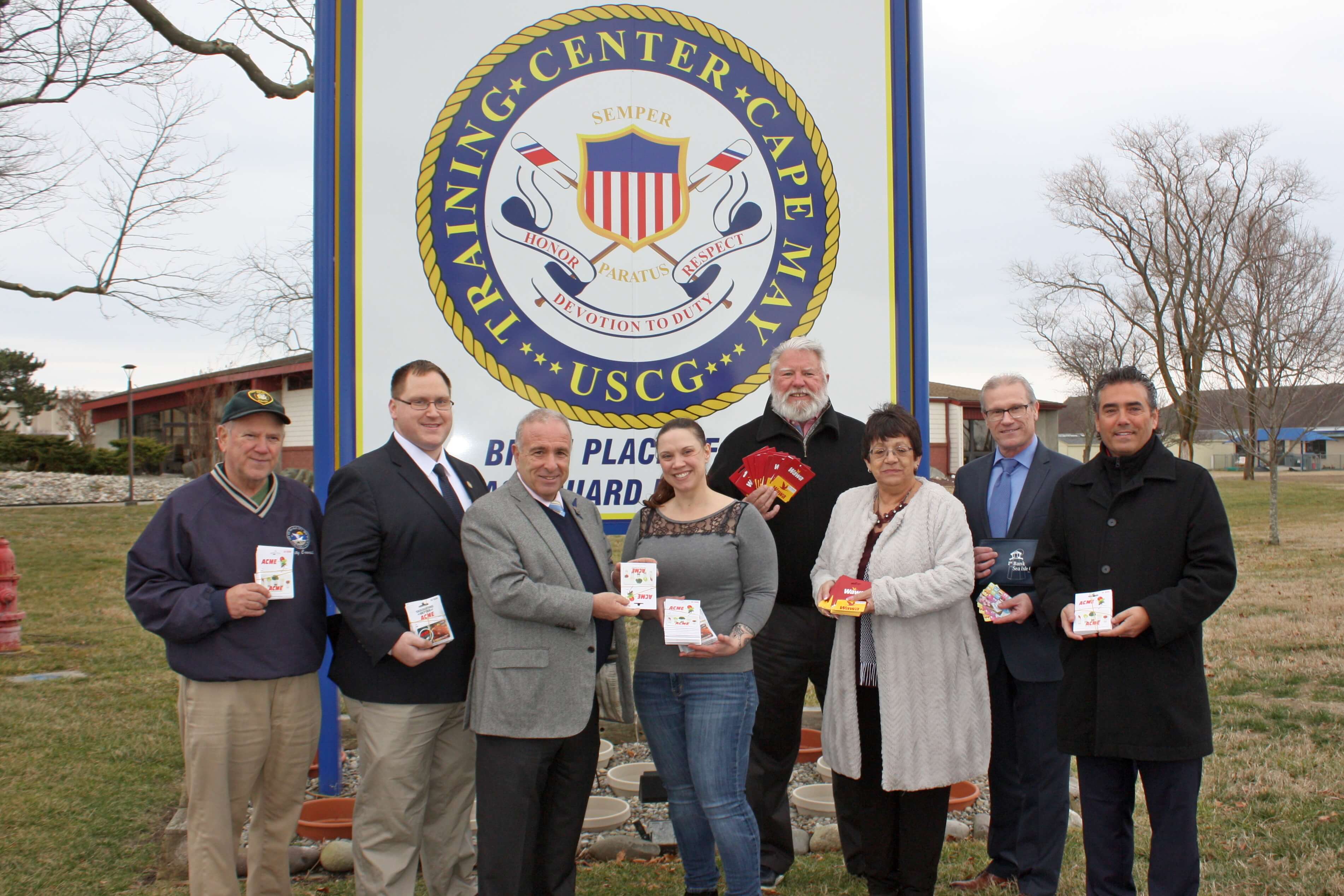  Accepting the gift cards and other items from Mayor Leonard Desiderio is Chief Petty Officer Kellie Dean