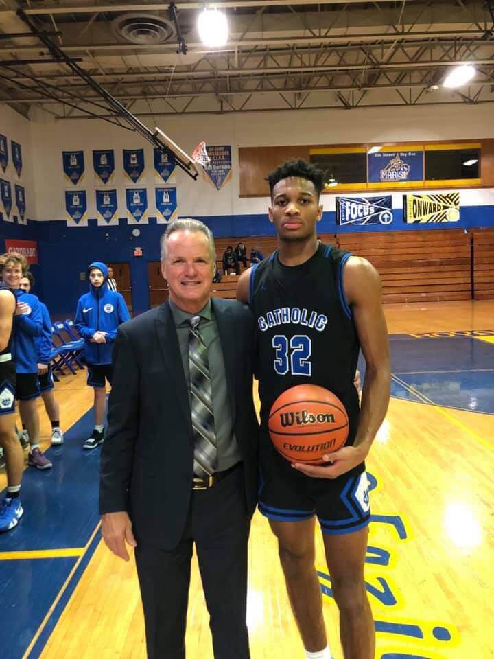 Taj Thweatt on home court with Coach DeWeese.