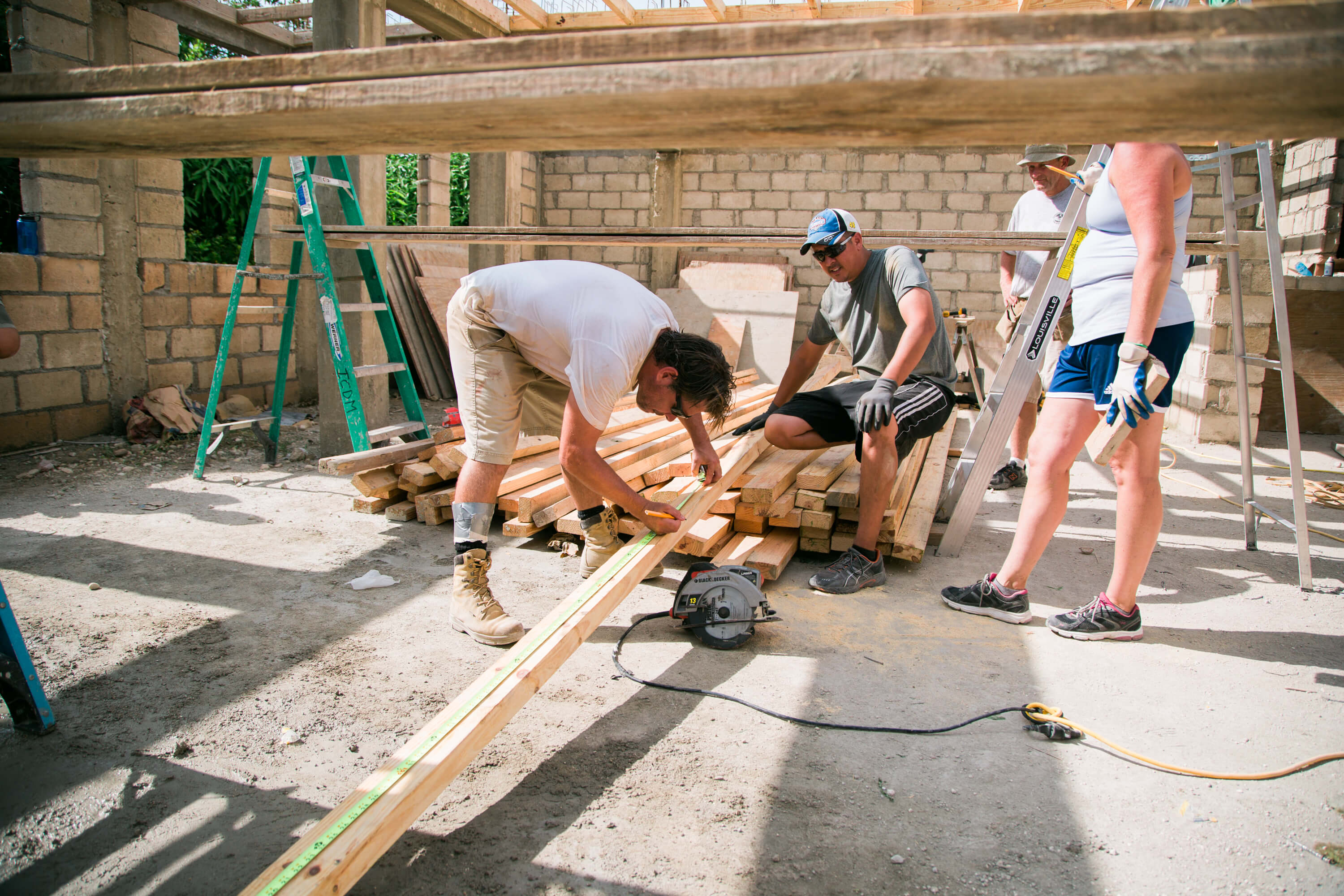 A crew from a Court House church frames windows for shutters on a home being built in Haiti.