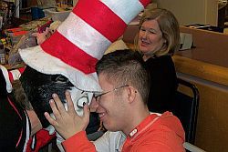 Tyler Sinone and Carol Taggart (1:1 aide) at Special Services School District during Read Across America Day.