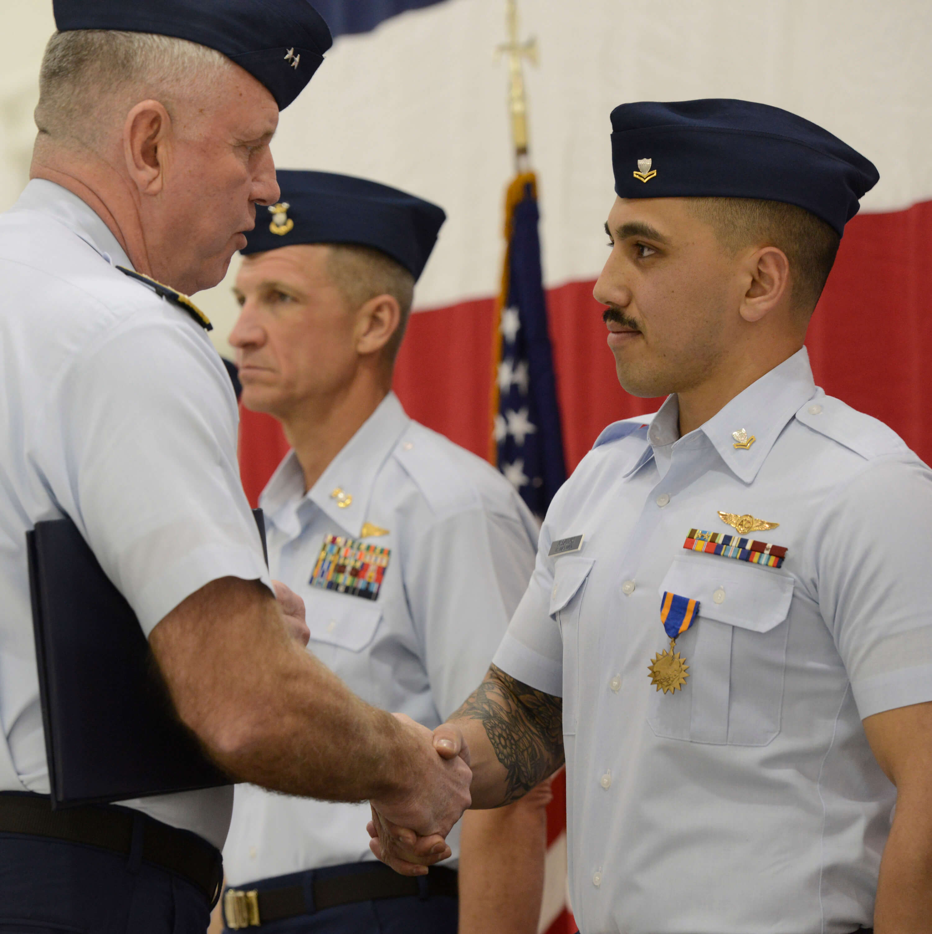 Petty Officer 2nd Class Brandon Abdallah shakes the hand of Rear Adm. Keith Smith