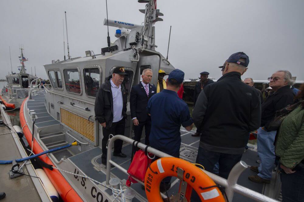 U.S. Rep. Jefferson Van Drew (D-2nd) and Assemblyman Bruce Land (D-1st) stand on the stern of a Station Cape May small boat during a tour of Training Center Cape May