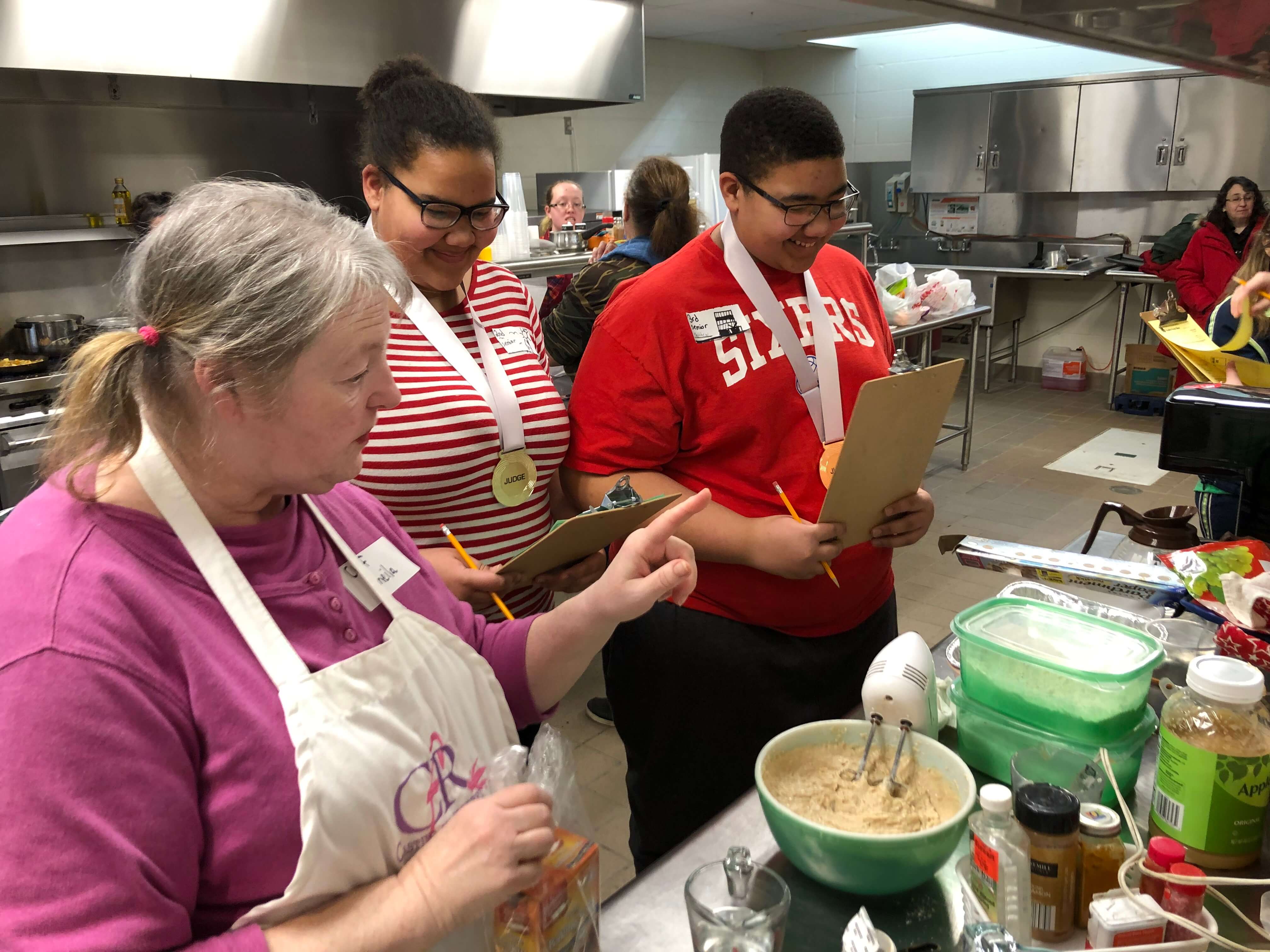 The tables are turned on volunteer Sheila Jargowski as 4-H youth members Hannah and Matthew Lashley judge her during the adult division of the annual 4-H Cooking Contest.