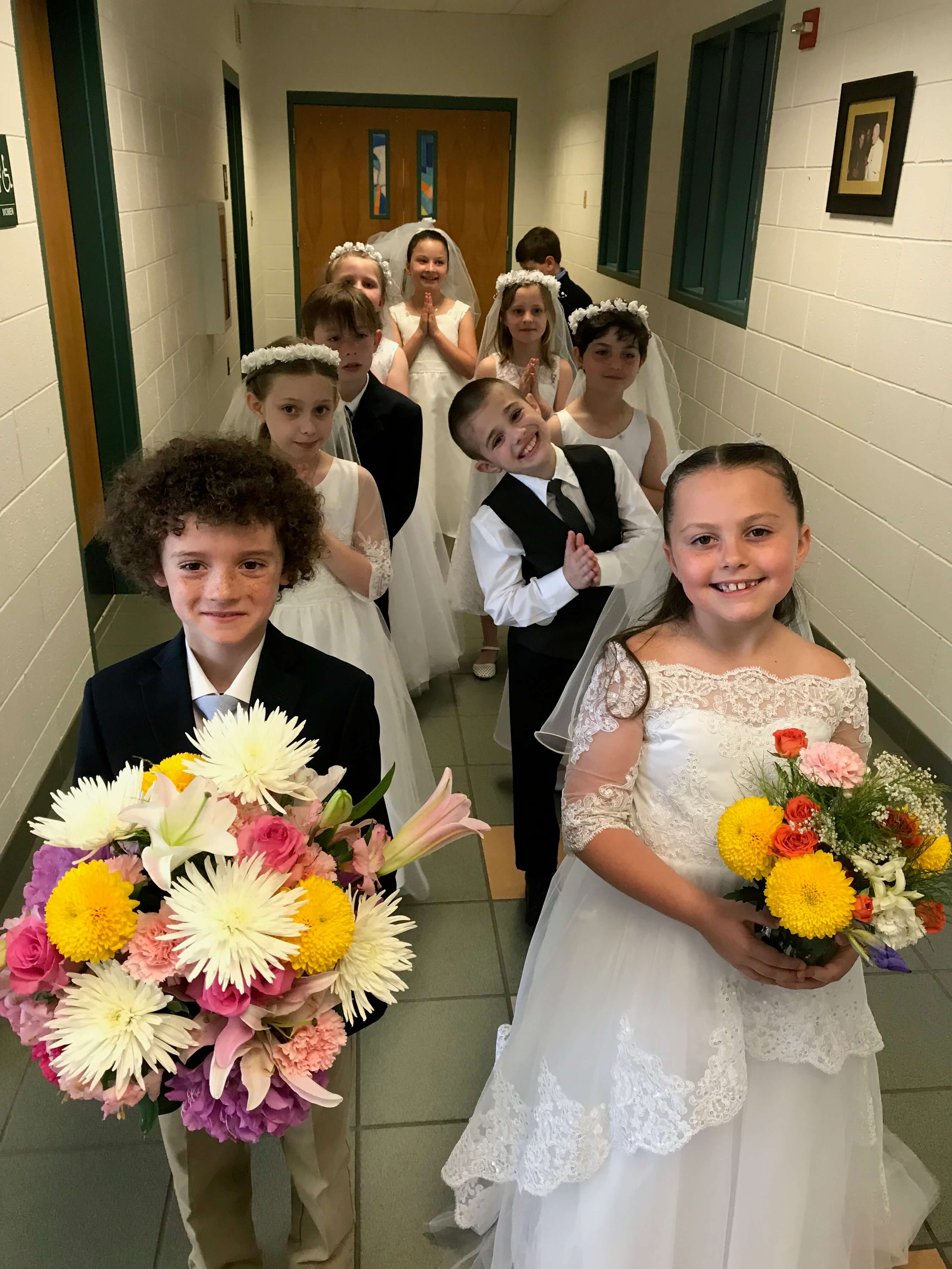 The second-grade class stands ready to lead the May Procession at Bishop McHugh School. Pictured from left: Andrew Catanoso