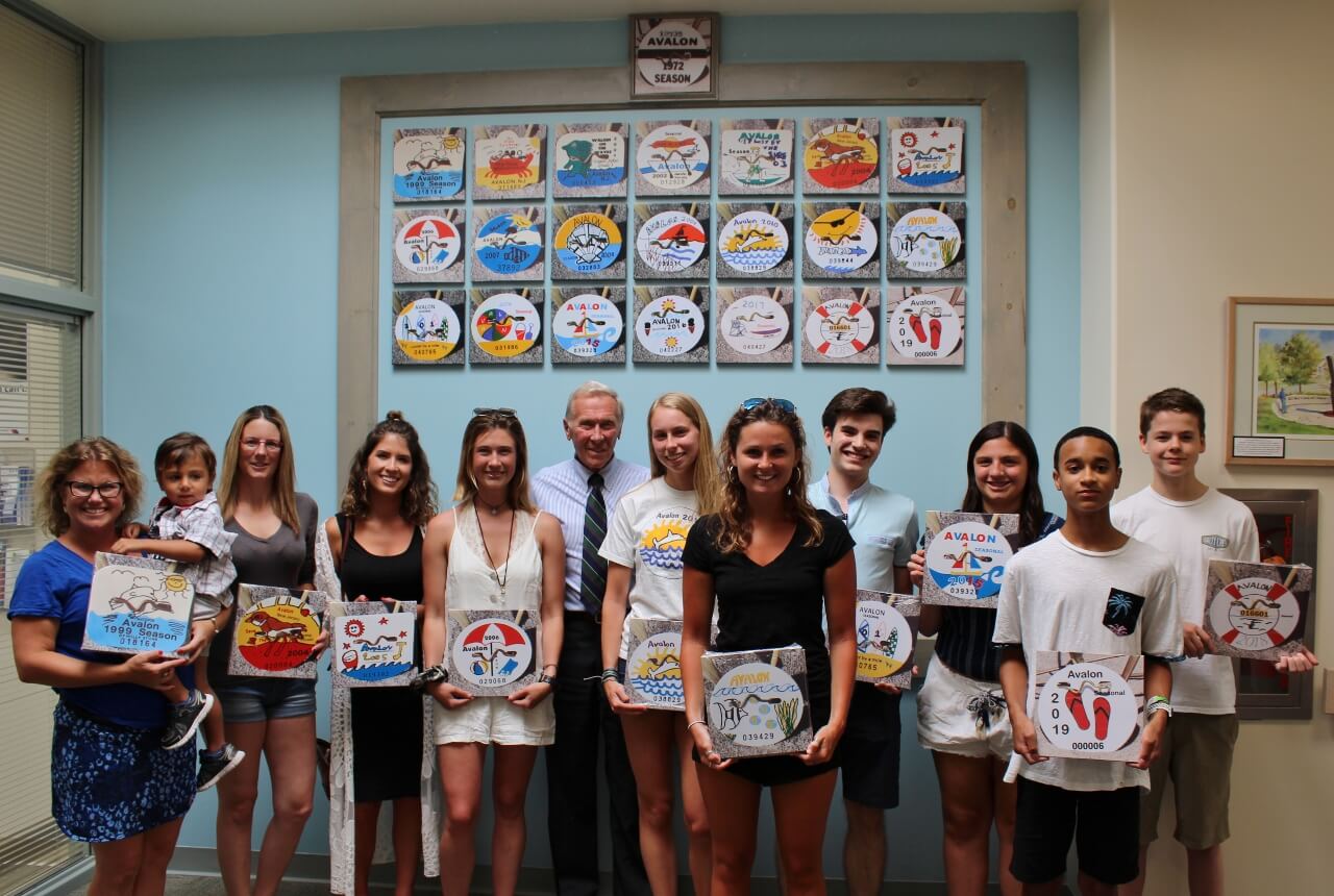 Honorees stand in front of the beach-tag wall June 26. 