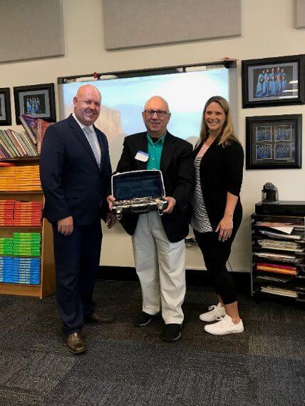 Larry Martino presents a clarinet to Valerie Aikens