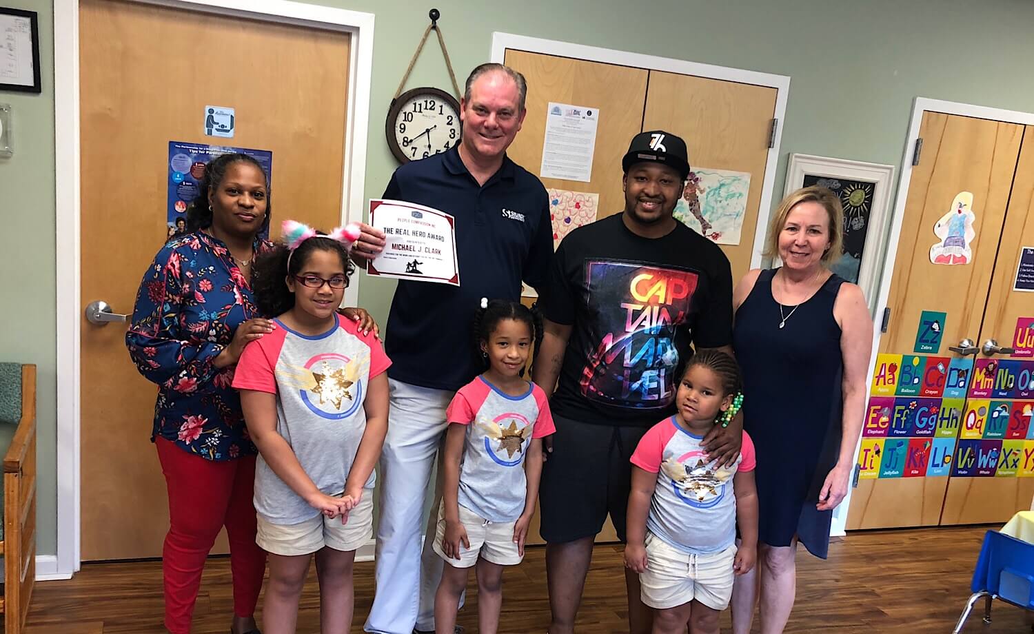 Middle Township Committeeman and former mayor Michael Clark holds hero award for public service presented by Alexander Bland during an event held at the Shore Family Success Center in Rio Grande.  