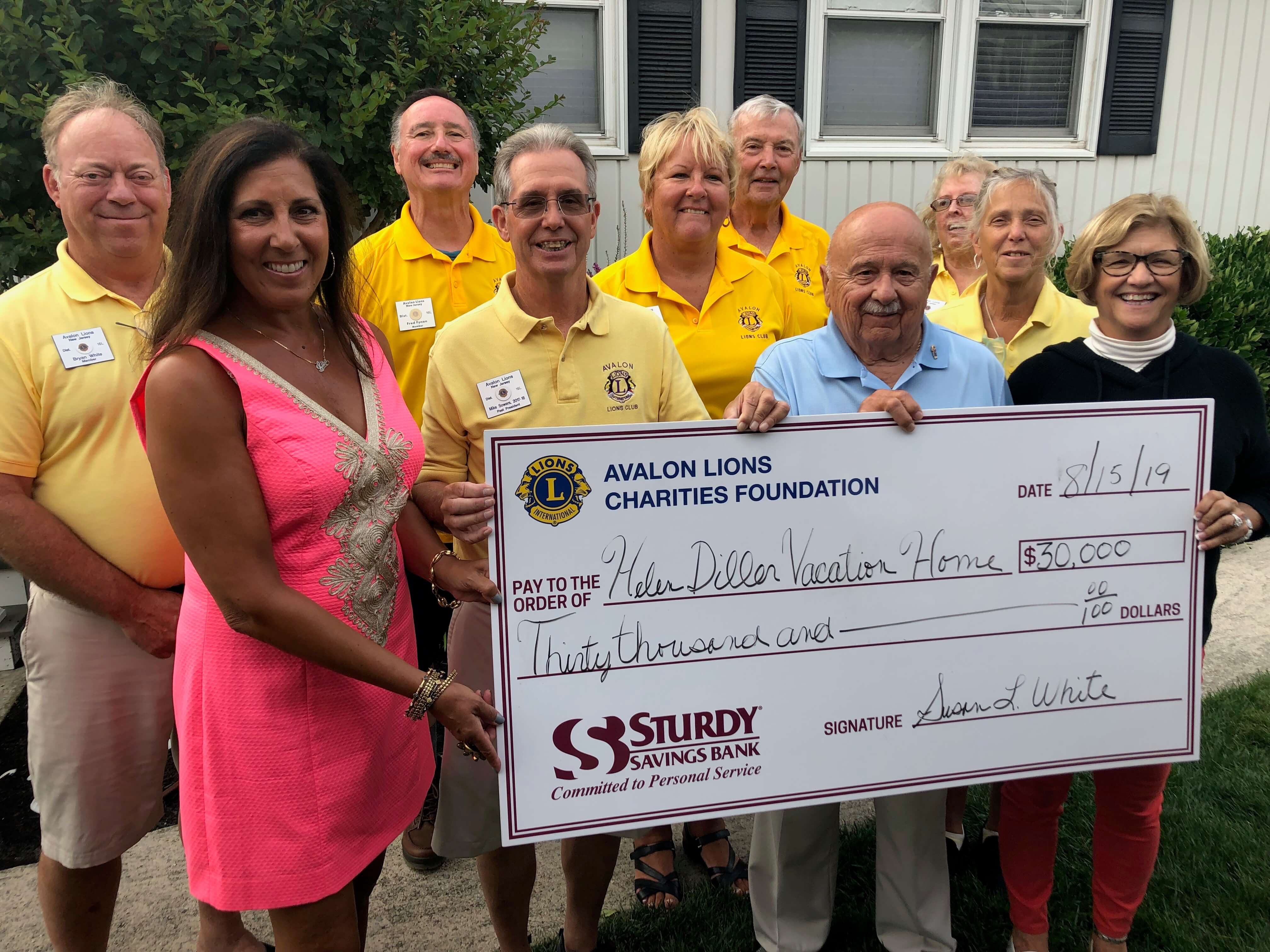Members of the Avalon Lions Club present the Helen L. Diller Vacation Home For Blind Children with a check of $30