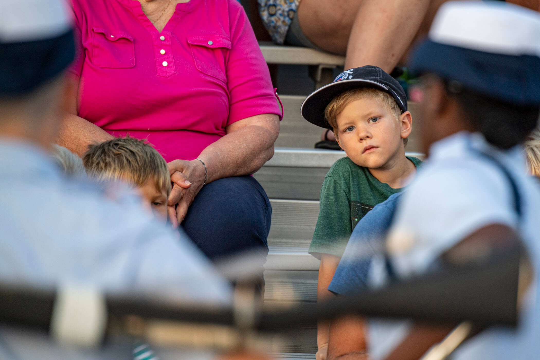 Youngster watches recruit company pass in review at a Sunset Parade in honor of the Jersey Cape Military Spouses Club and local community organizations and to recognize the Coast Guard’s 229th birthday