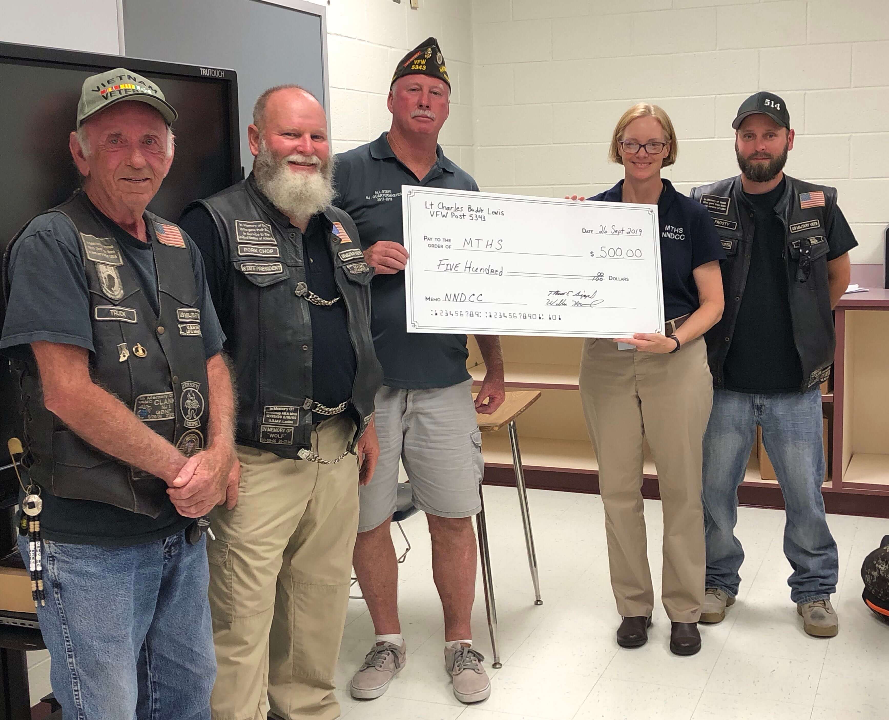 Representatives from Villas VFW Post 5343 present a $500 donation check to Commander Blood and students. Pictured left to right: Joseph Kremp