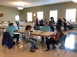 Workers at St. Paul Church sew dresses for girls in Third World nations.