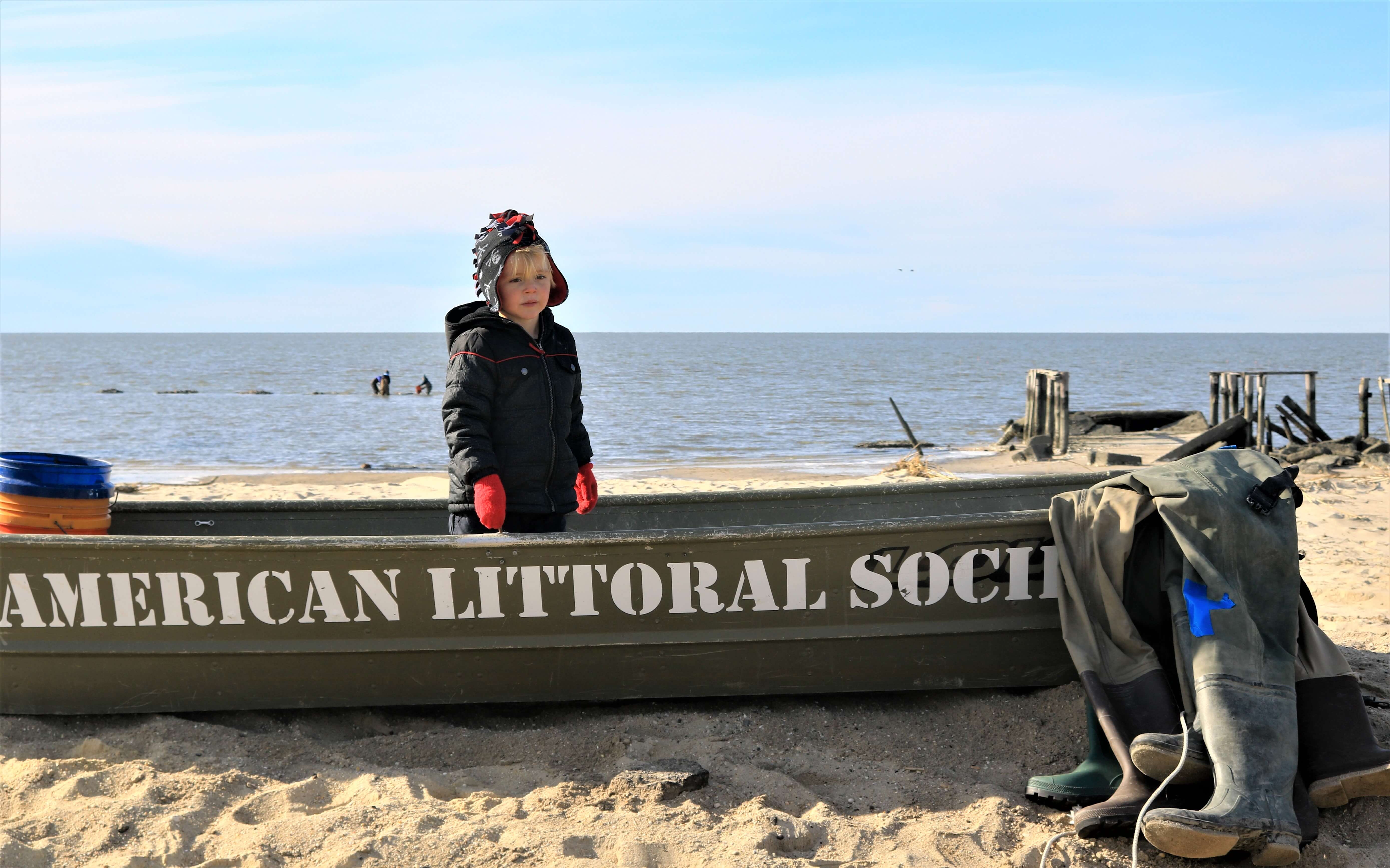 Unidentified youngster takes part in the dedication of three reefs to veterans at Cook's Beach in Dias Creek Nov. 11.
