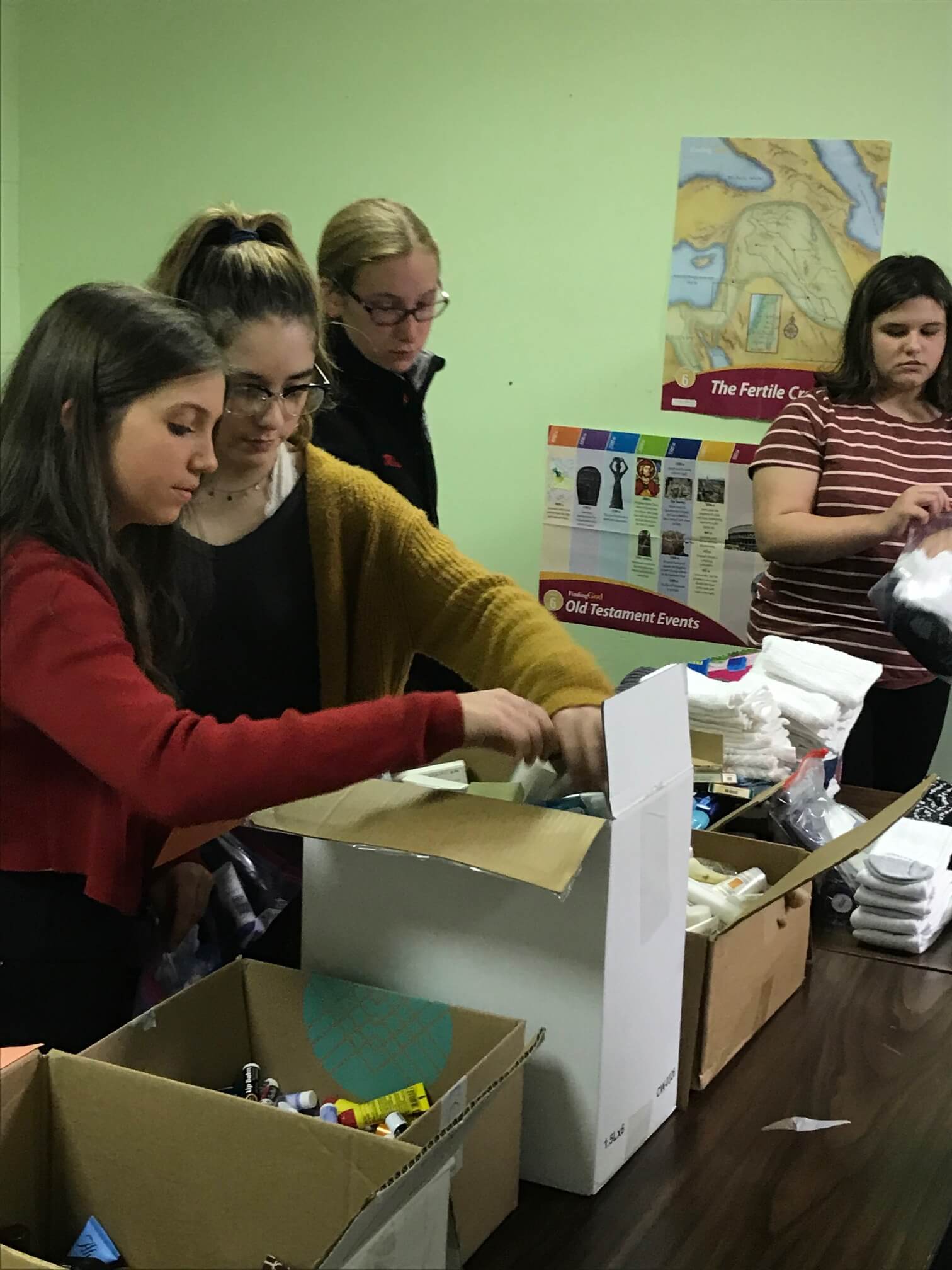 Parishioners of St. Maximilian Kolbe pack bags to aid the homeless.